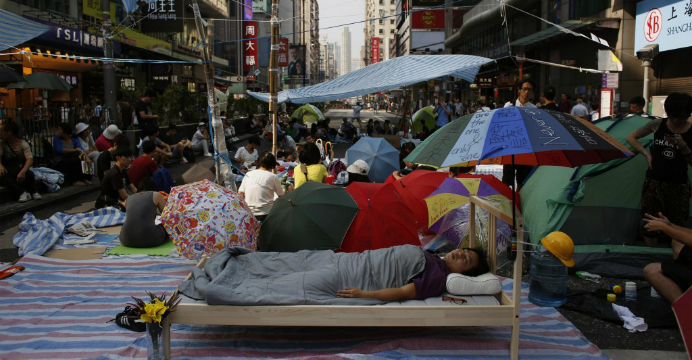 A protester sleeps in his own bed in Nathan Road as other demonstrators continue their sit-in. Photo: RTHK A protester sleeps in his own bed in Nathan Road as other demonstrators continue their sit-in. Photo: RTHK