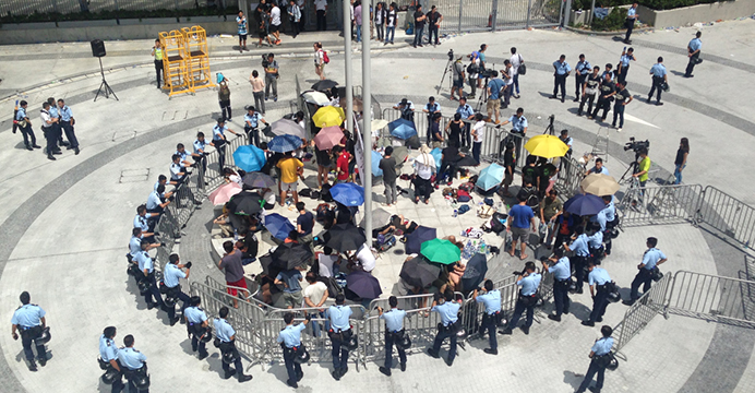 Student protesters are surrounded by police in Civic Square on Sept. 27. The government has rejected calls for the reopening of the square, citing security concerns. Photo: TIME Student protesters are surrounded by police in Civic Square on Sept. 27. The government has rejected calls for the reopening of the square, citing security concerns. Photo: TIME