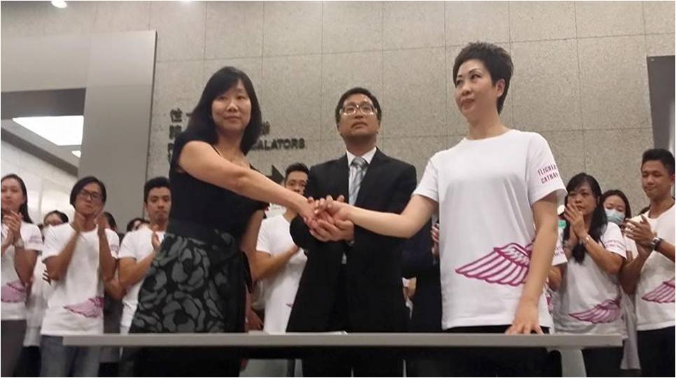 Cathay Pacific Airways Flight Attendants Union chairwoman Dora Lai Yuk-sim (R) shakes hands with a management representative after reaching a deal over pay and benefits. A Labor Department official is seen standing behind the duo. Photo: SocRec Cathay Pacific Airways Flight Attendants Union chairwoman Dora Lai Yuk-sim (R) shakes hands with a management representative after reaching a deal over pay and benefits. A Labor Department official is seen standing behind the duo. Photo: SocRec