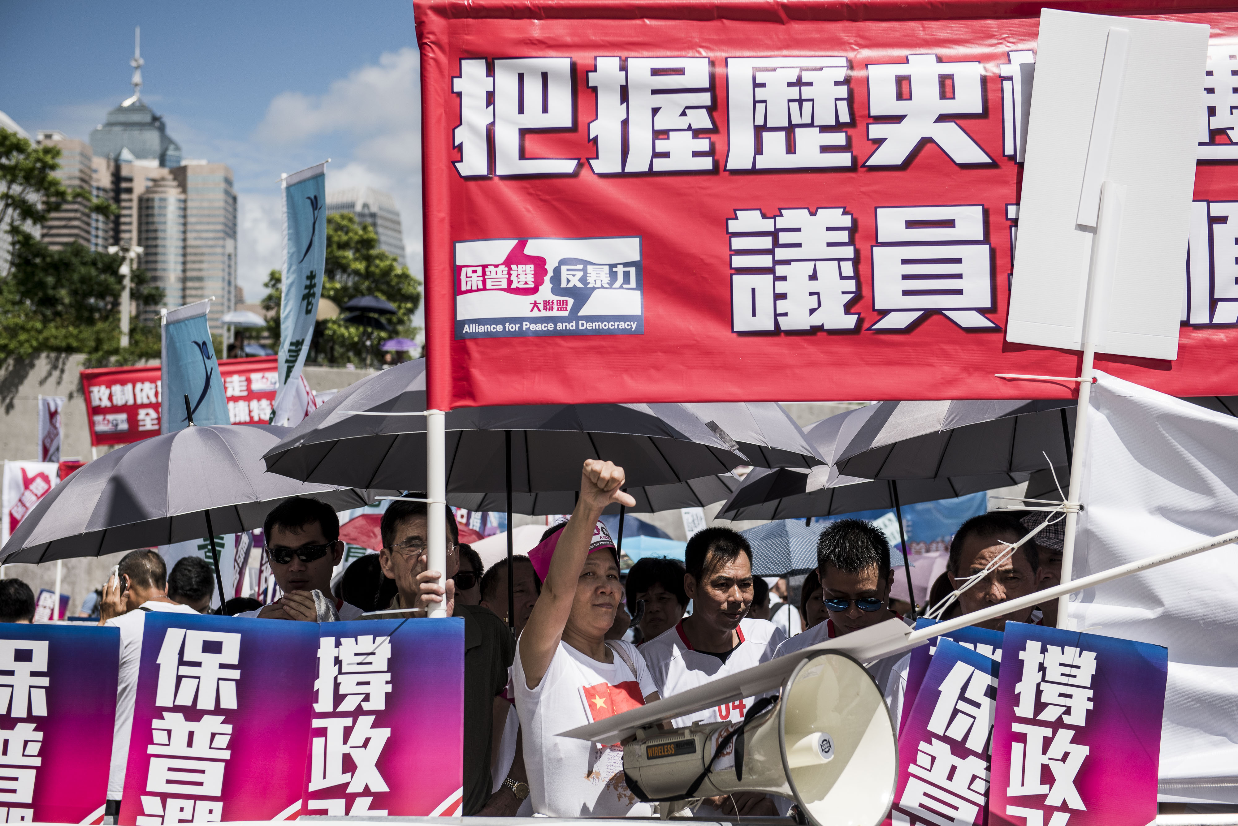 Supporters of the election bill hold banners during a demonstration outside the Legislative Council complex. Photo: Bloomberg Supporters of the election bill hold banners during a demonstration outside the Legislative Council complex. Photo: Bloomberg