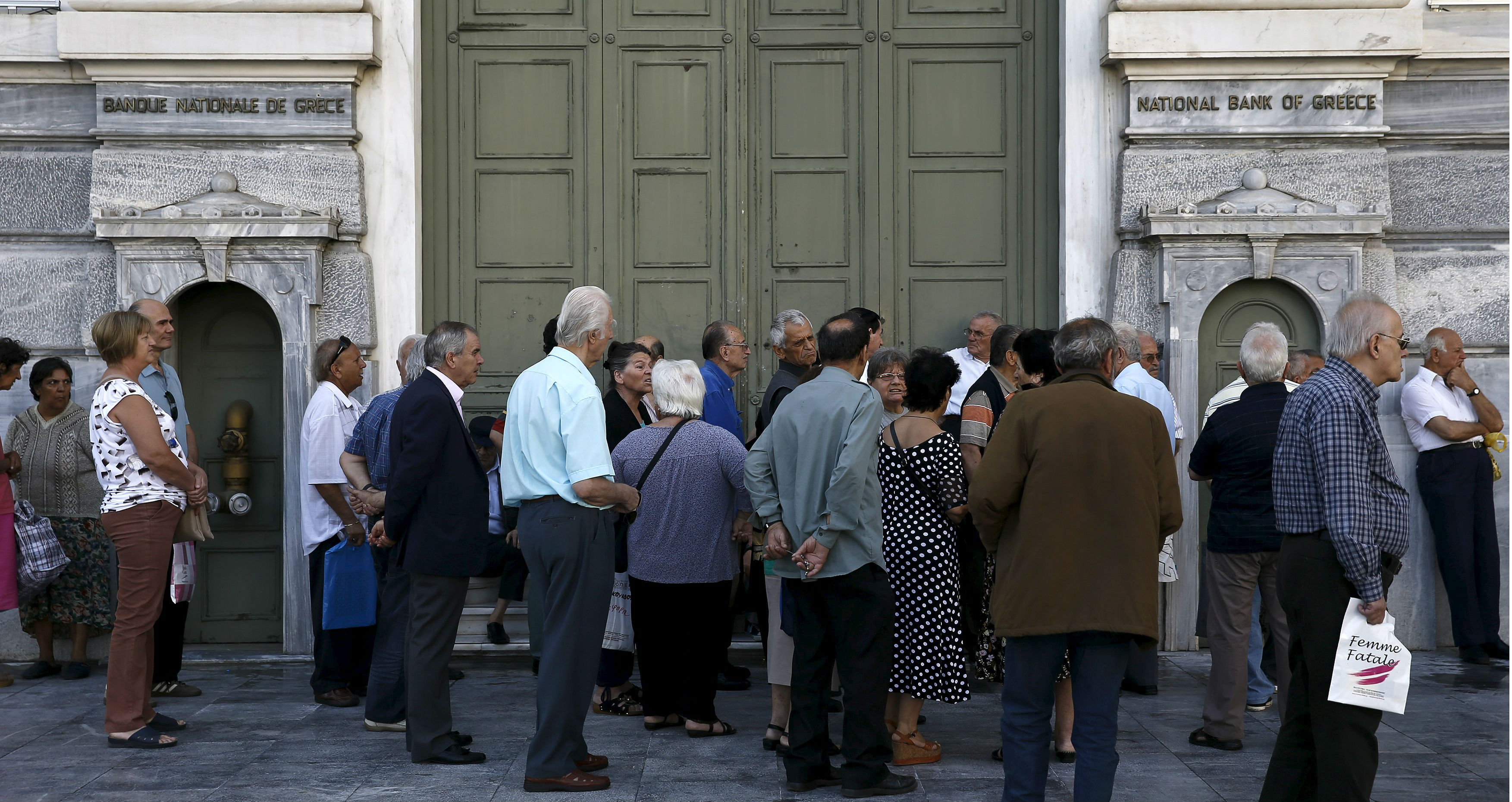Pensioners gather outside a closed branch of the National Bank of Greece in Athens on Monday. Photo: Reuters Pensioners gather outside a closed branch of the National Bank of Greece in Athens on Monday. Photo: Reuters