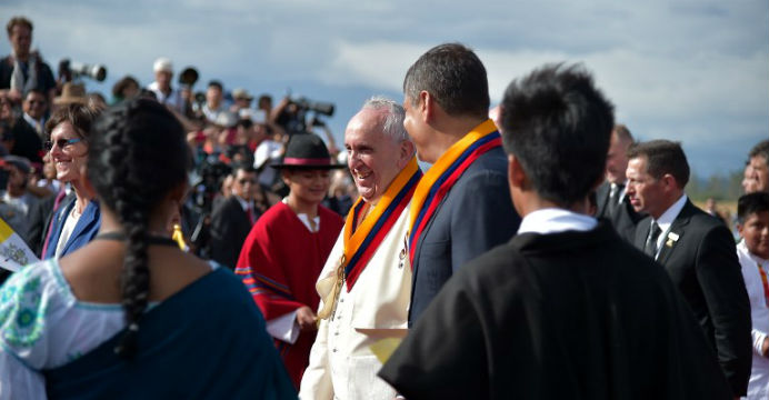 Pope Francis (in white) is escorted by Rafael Correa upon arriving in Ecuador. Photo: AFP Pope Francis (in white) is escorted by Rafael Correa upon arriving in Ecuador. Photo: AFP