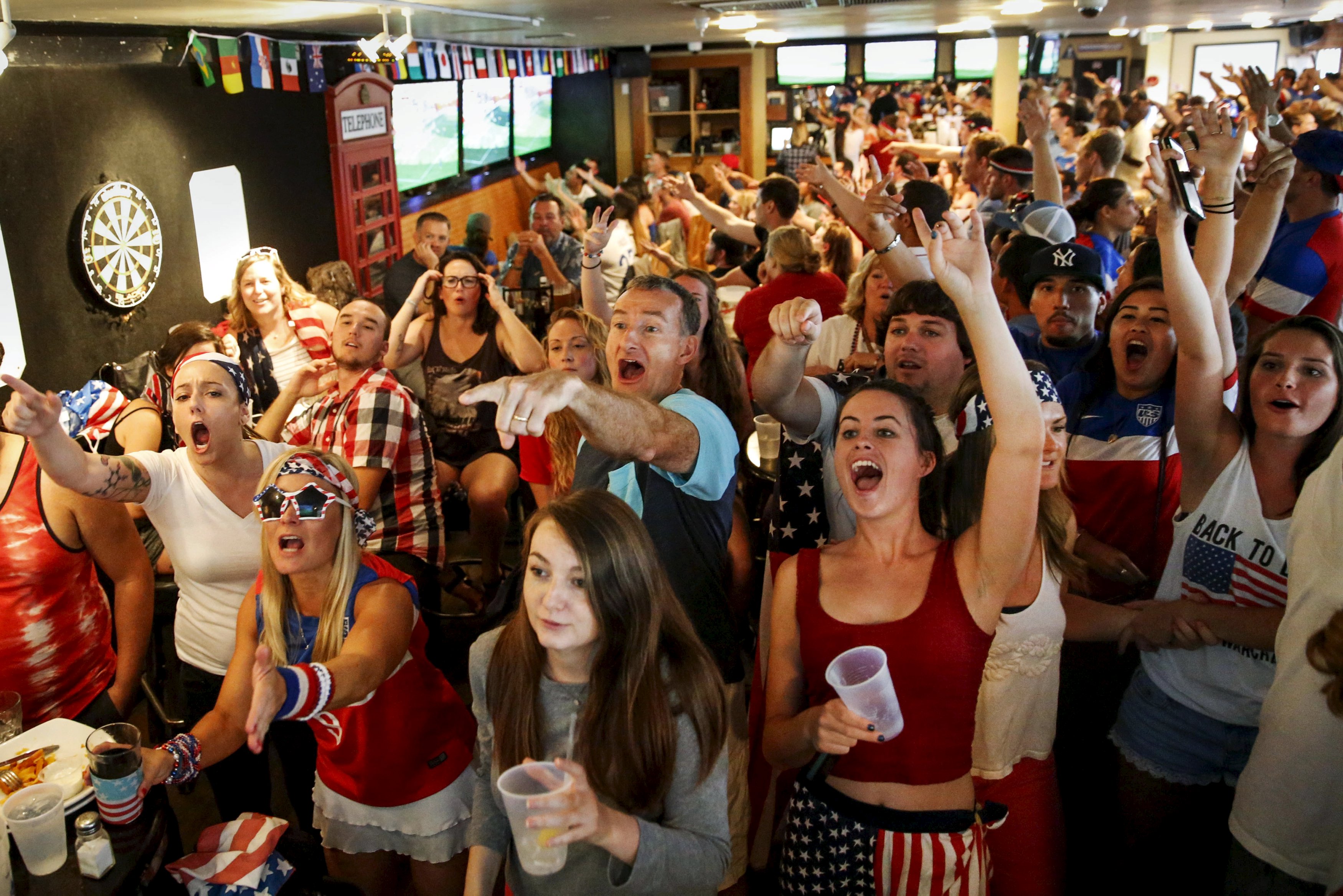 US fans watch the women's World Cup final against Japan on a monitor inside a bar. Fox scored a ratings coup with a record 25.4 million viewers. Photo: Reuters US fans watch the women's World Cup final against Japan on a monitor inside a bar. Fox scored a ratings coup with a record 25.4 million viewers. Photo: Reuters
