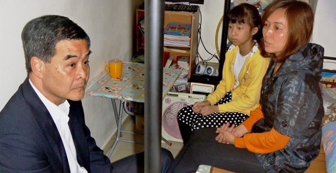Chief Executive Leung Chun-ying visits a family living in a 50 square foot subdivided flat. He can commiserate with them but still he owns a villa on the Peak and lives in the spacious Government House in Central. Photo: RTHK Chief Executive Leung Chun-ying visits a family living in a 50 square foot subdivided flat. He can commiserate with them but still he owns a villa on the Peak and lives in the spacious Government House in Central. Photo: RTHK