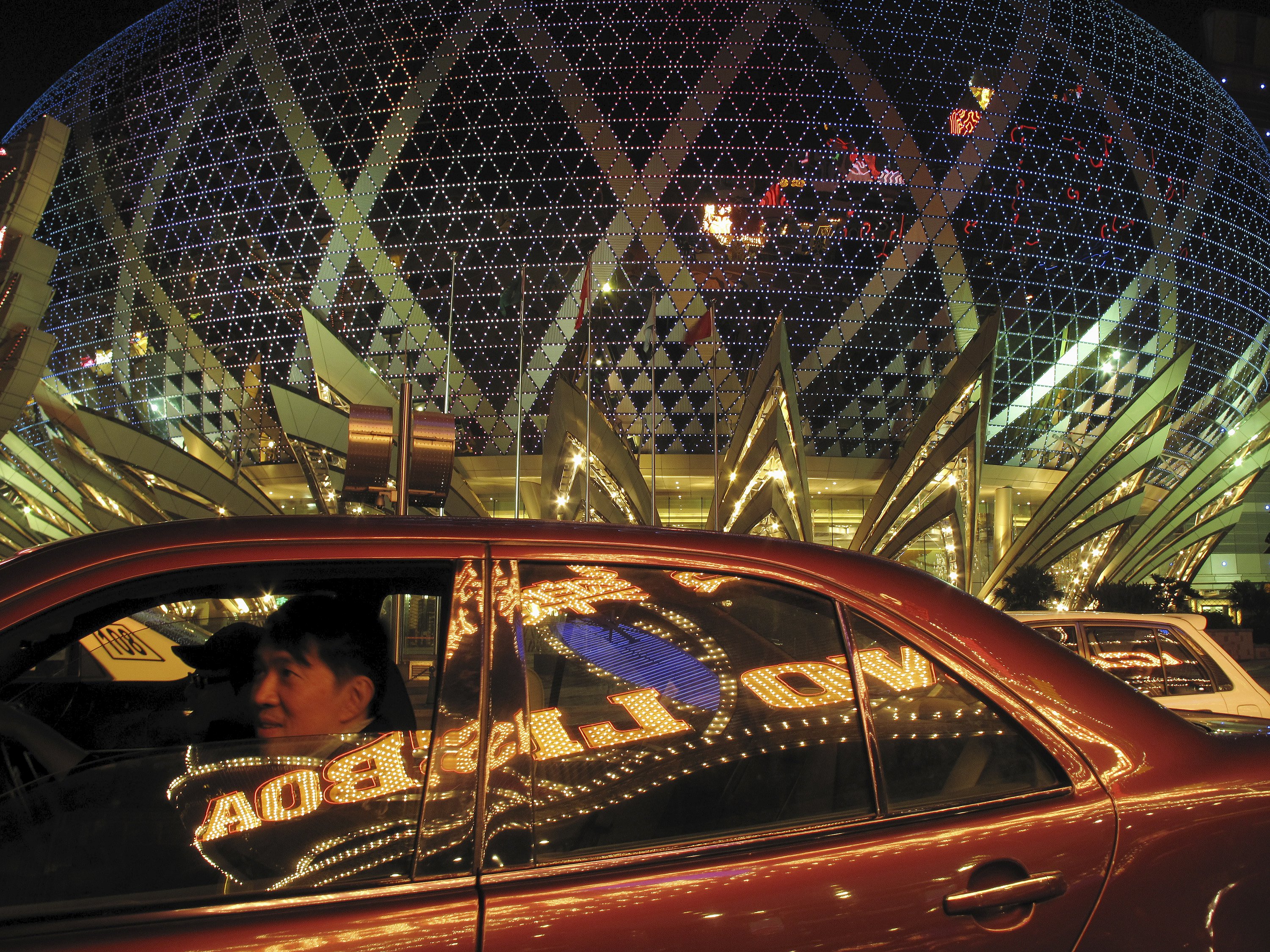Casino Lisboa is reflected on the window of a Macau taxi. The Stanley Ho flagship lost its gaming monopoly 2002. Not since then has Macau's gambling industry has suffered a steep slowdown until now. Photo: Reuters Casino Lisboa is reflected on the window of a Macau taxi. The Stanley Ho flagship lost its gaming monopoly 2002. Not since then has Macau's gambling industry has suffered a steep slowdown until now. Photo: Reuters