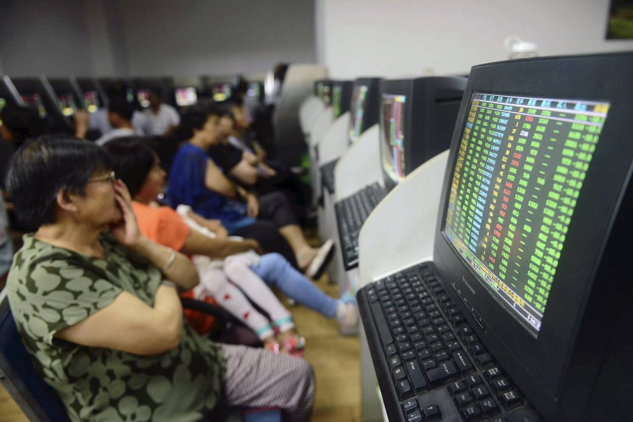 Investors watch with horror as stocks plunge to their biggest one-day loss in more than eight years. Photo: Reuters Investors watch with horror as stocks plunge to their biggest one-day loss in more than eight years. Photo: Reuters