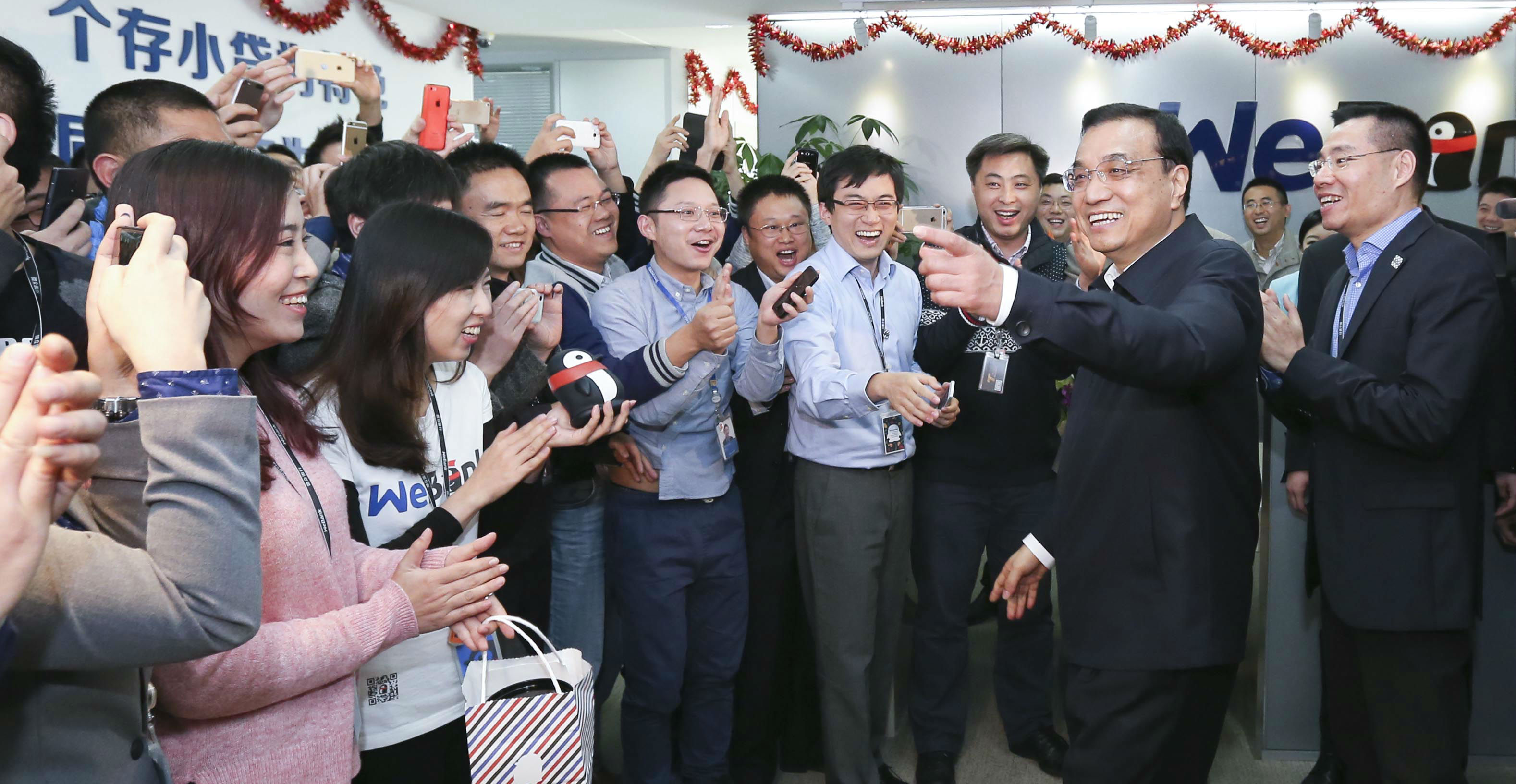 Chinese Premier Li Keqiang (second from right) visits the Shenzhen office of WeBank in January. Photo: Xinhua Chinese Premier Li Keqiang (second from right) visits the Shenzhen office of WeBank in January. Photo: Xinhua
