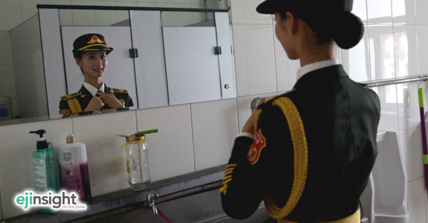 A female officer from the military band fine-tunes her appearance in front of a mirror in the gents' quarters ahead of Thursday's military parade in Beijing. Photo: news.ifeng.com A female officer from the military band fine-tunes her appearance in front of a mirror in the gents' quarters ahead of Thursday's military parade in Beijing. Photo: news.ifeng.com
