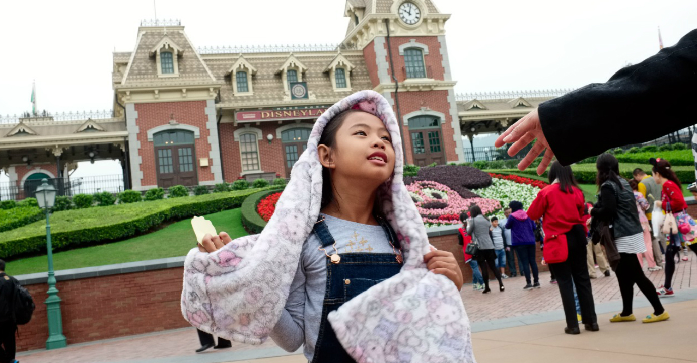 Domestic worker Bhing reaches out to her daughter Dominique at Hong Kong Disneyland. Domestic worker Bhing reaches out to her daughter Dominique at Hong Kong Disneyland.