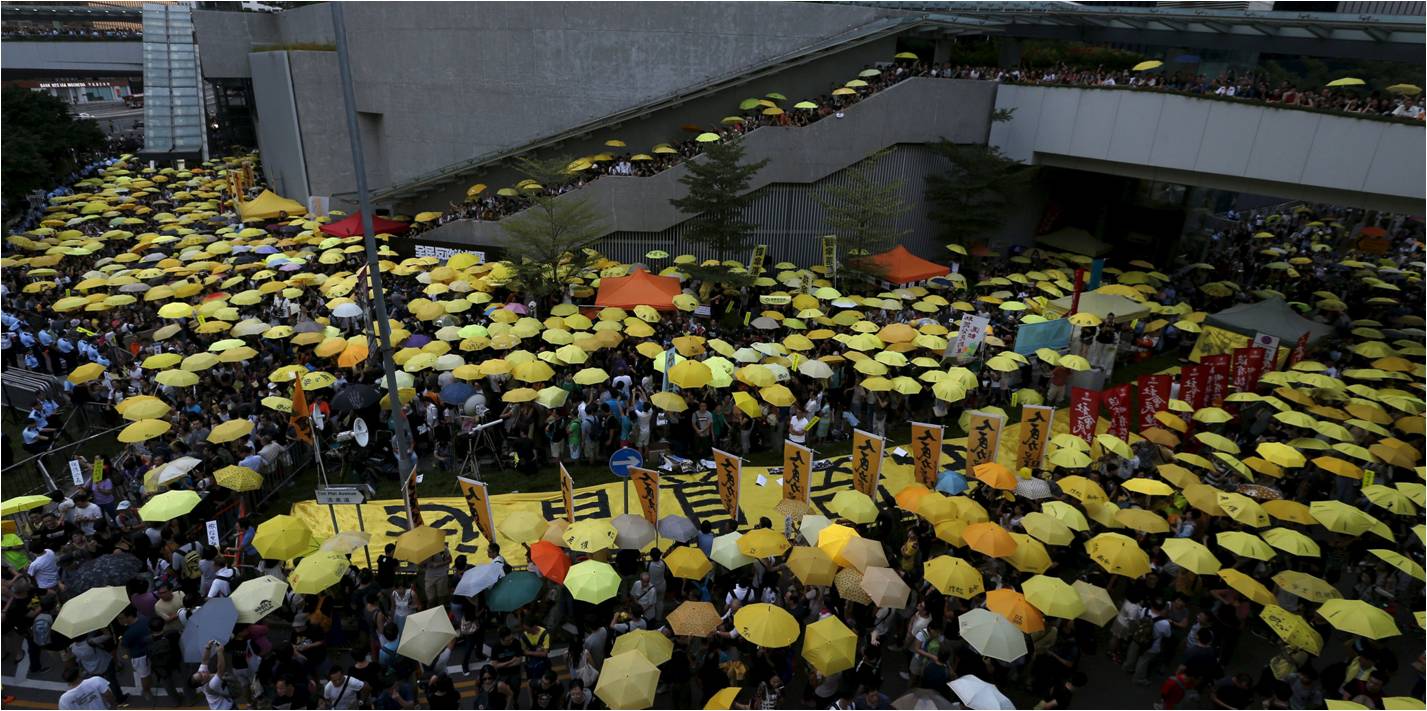 Activists hold aloft yellow umbrellas in a rally outside government headquarters Monday to mark the first anniversary of the launch of the Occupy movement. Photo: Reuters Activists hold aloft yellow umbrellas in a rally outside government headquarters Monday to mark the first anniversary of the launch of the Occupy movement. Photo: Reuters