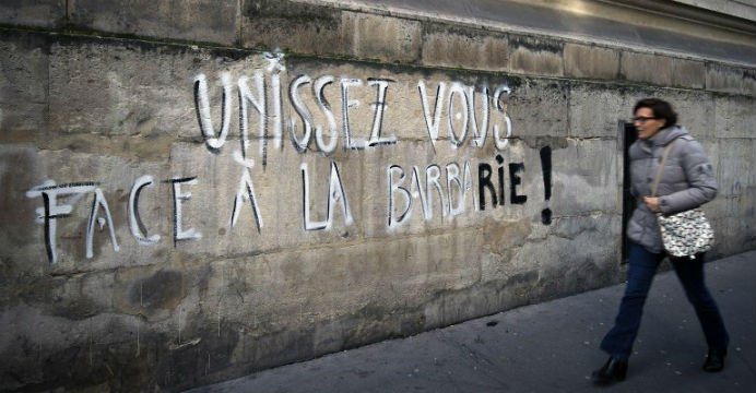 'Unite against barbarism!' is scribbled in French on a wall in Paris. Photo: AFP 'Unite against barbarism!' is scribbled in French on a wall in Paris. Photo: AFP