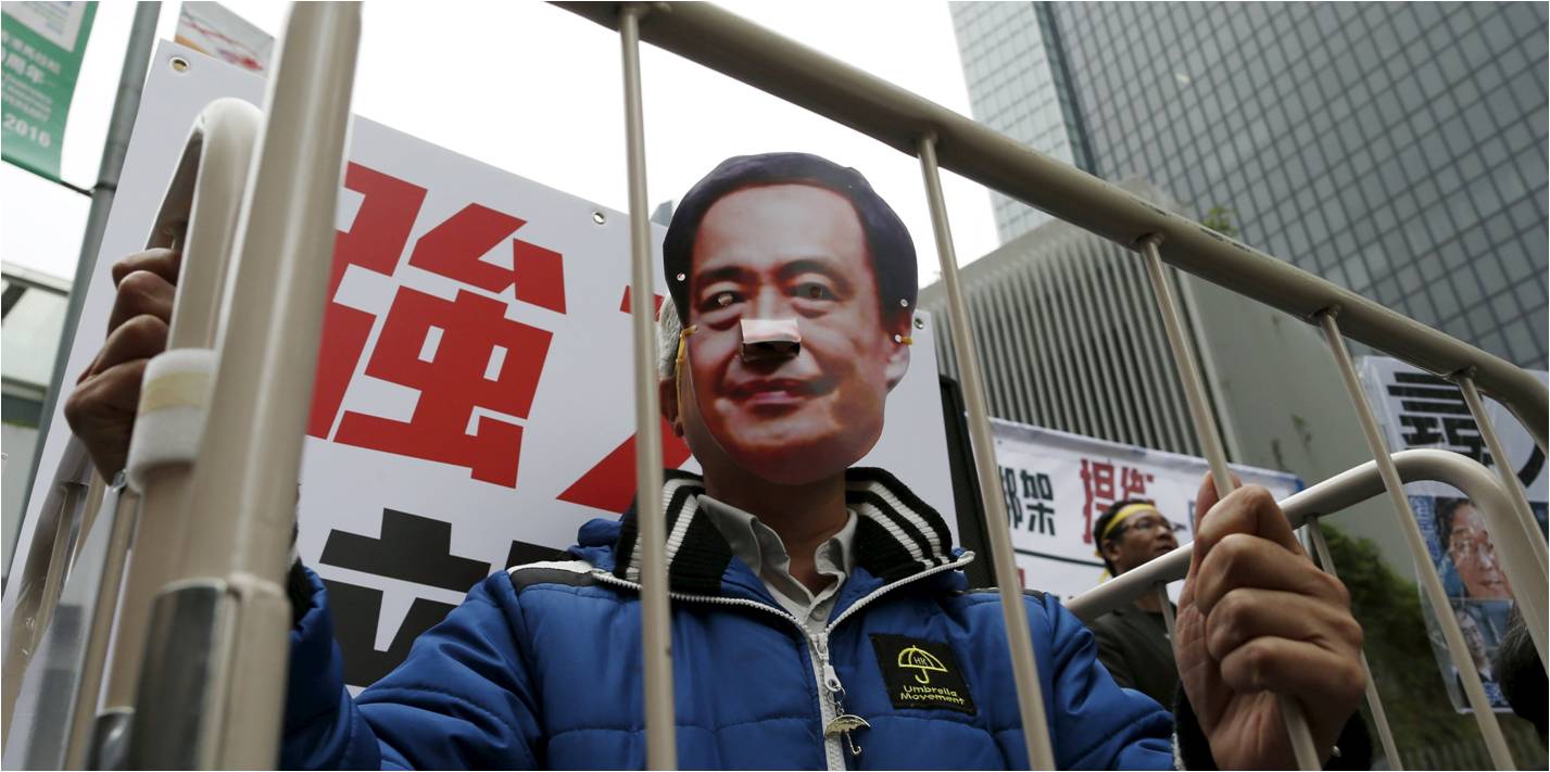 A demonstrator wears a mask depicting Causeway Bay Books shareholder Lee Bo during a protest over the disappearance of five Hong Kong booksellers. Photo: Reuters A demonstrator wears a mask depicting Causeway Bay Books shareholder Lee Bo during a protest over the disappearance of five Hong Kong booksellers. Photo: Reuters