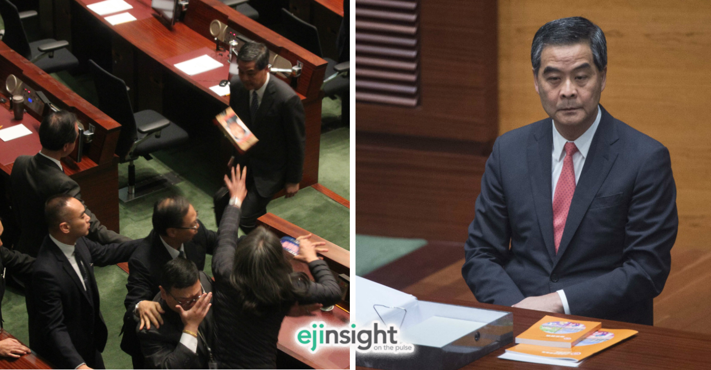 Perhaps the only one who was satisfied with the policy address was CY Leung himself. Long Hair Leung Kwok-hung, shown at left throwing a shoe brush at CY Leung, was obviously not impressed. Photo: HKEJ Perhaps the only one who was satisfied with the policy address was CY Leung himself. Long Hair Leung Kwok-hung, shown at left throwing a shoe brush at CY Leung, was obviously not impressed. Photo: HKEJ