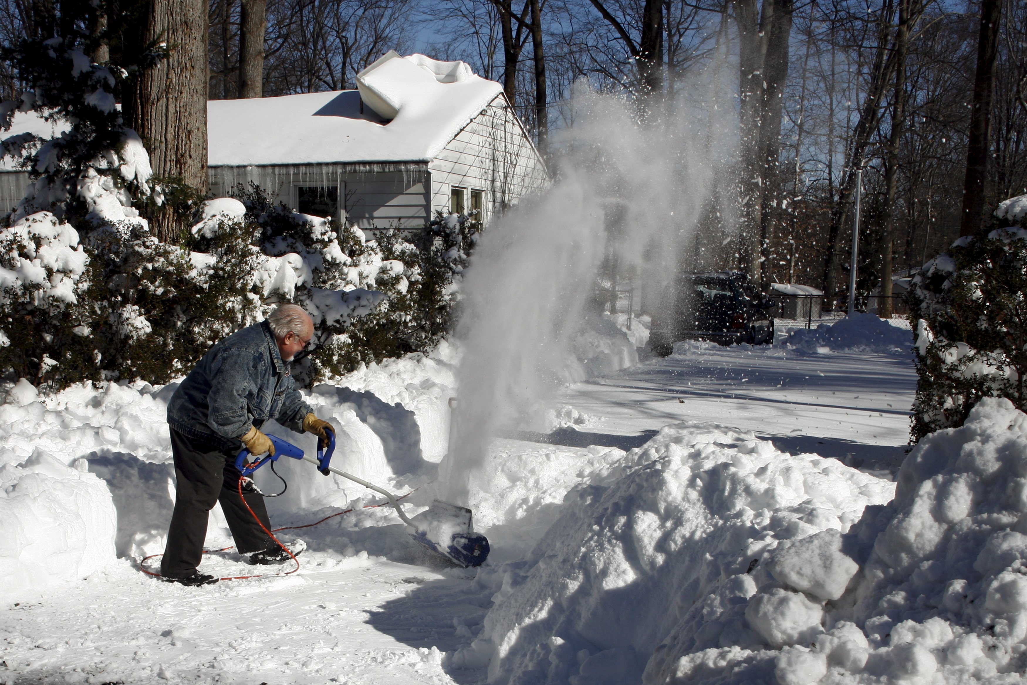 A man clears away snow in his front yard. The blizzard dumped up to 26 inches of snow in New York and Washington D.C. Photo: Reuters A man clears away snow in his front yard. The blizzard dumped up to 26 inches of snow in New York and Washington D.C. Photo: Reuters