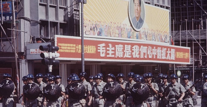 Members of the Royal Hong Kong Police patrol the streets after the 1967 riots that claimed 51 lives. A portrait of Mao Zedong is seen in the background, with the slogan that reads "Chairman Mao is the Red Sun in our hearts". Photo: Internet Members of the Royal Hong Kong Police patrol the streets after the 1967 riots that claimed 51 lives. A portrait of Mao Zedong is seen in the background, with the slogan that reads "Chairman Mao is the Red Sun in our hearts". Photo: Internet