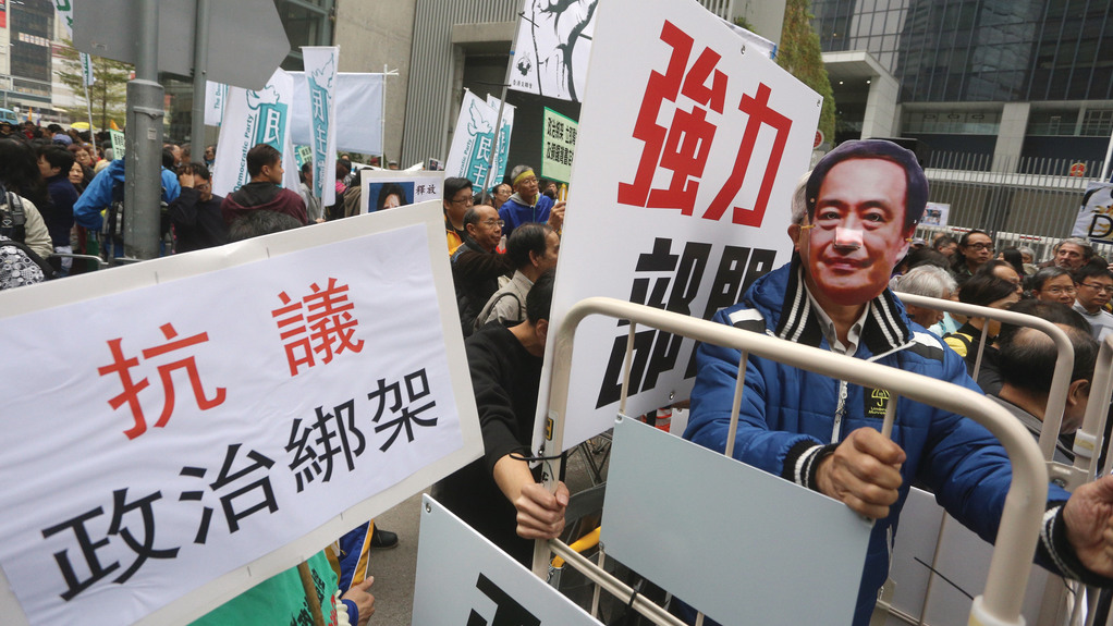 A protester wears a mask of Lee Bo in a rally outside China's liaison office. Lee is believed to have been hijacked by mainland agents in Hong Kong. Photo: Internet A protester wears a mask of Lee Bo in a rally outside China's liaison office. Lee is believed to have been hijacked by mainland agents in Hong Kong. Photo: Internet