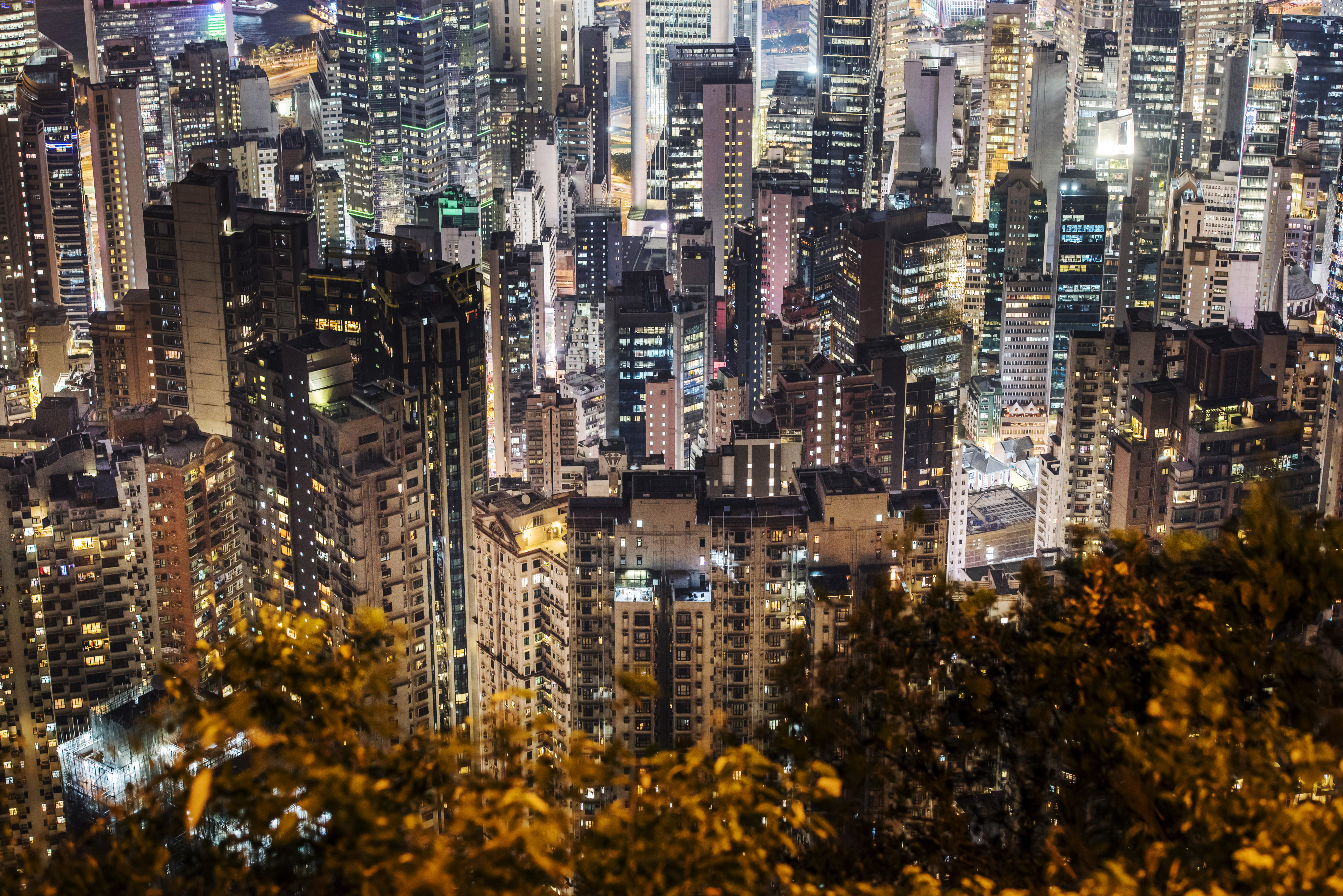 Residential and commercial buildings in Central and Sheung Wan are ablaze with lights at night. The government aims to rezone some tiny plots in dense urban areas for residential purposes. Photo: Bloomberg Residential and commercial buildings in Central and Sheung Wan are ablaze with lights at night. The government aims to rezone some tiny plots in dense urban areas for residential purposes. Photo: Bloomberg
