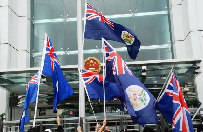Activists wave British colonial flags outside Beijing's Liaison Office in Hong Kong. Political vetting has disqualified key pro-independence candidates from the Sept. 4 Legco elections. Photo: Internet Activists wave British colonial flags outside Beijing's Liaison Office in Hong Kong. Political vetting has disqualified key pro-independence candidates from the Sept. 4 Legco elections. Photo: Internet