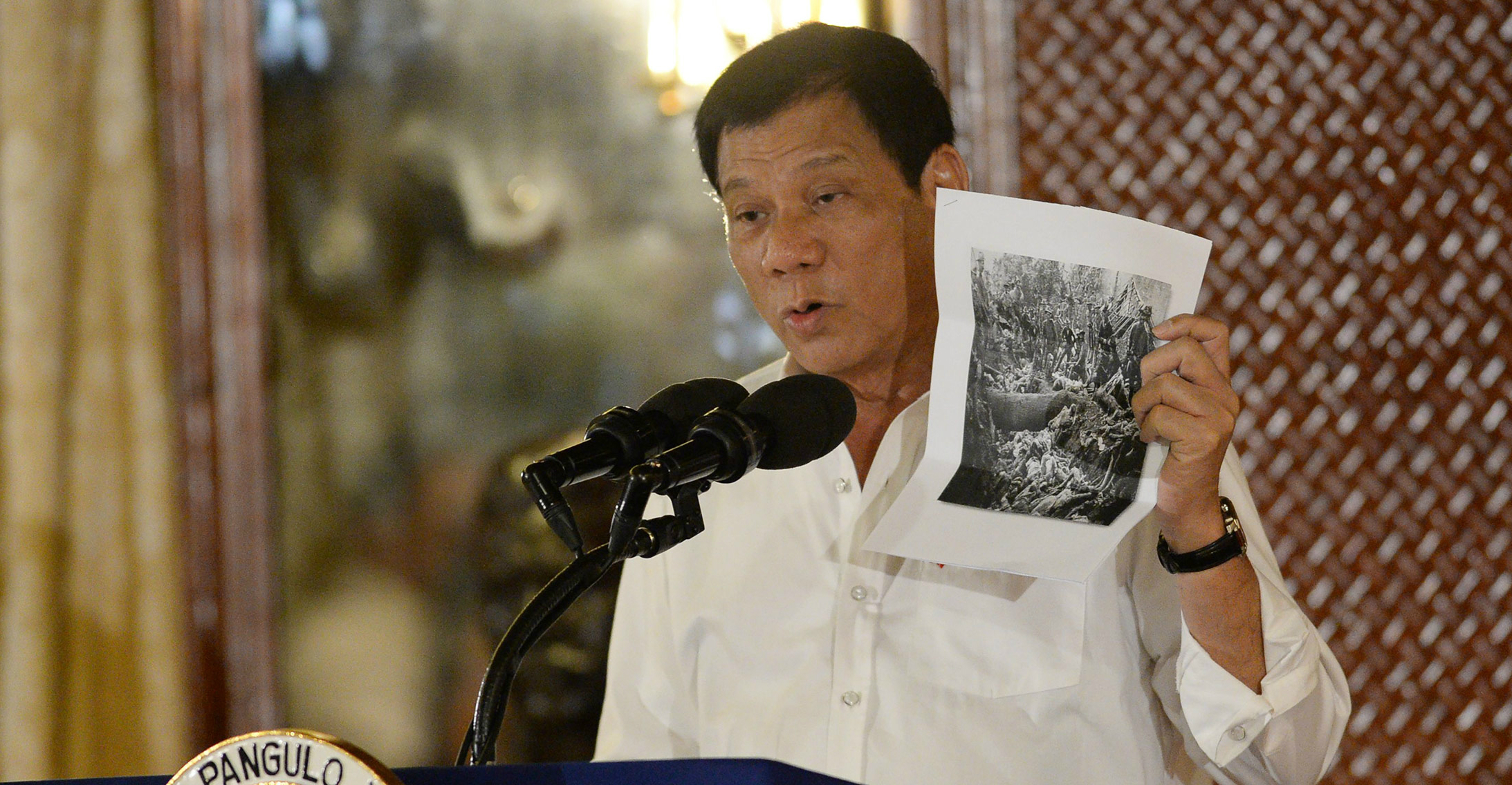 President Rodrigo Duterte holds up a photo, citing accounts of US troops who have killed Muslims during the US occupation of the Philippines in the early-1900s. Photo: Bloomberg President Rodrigo Duterte holds up a photo, citing accounts of US troops who have killed Muslims during the US occupation of the Philippines in the early-1900s. Photo: Bloomberg