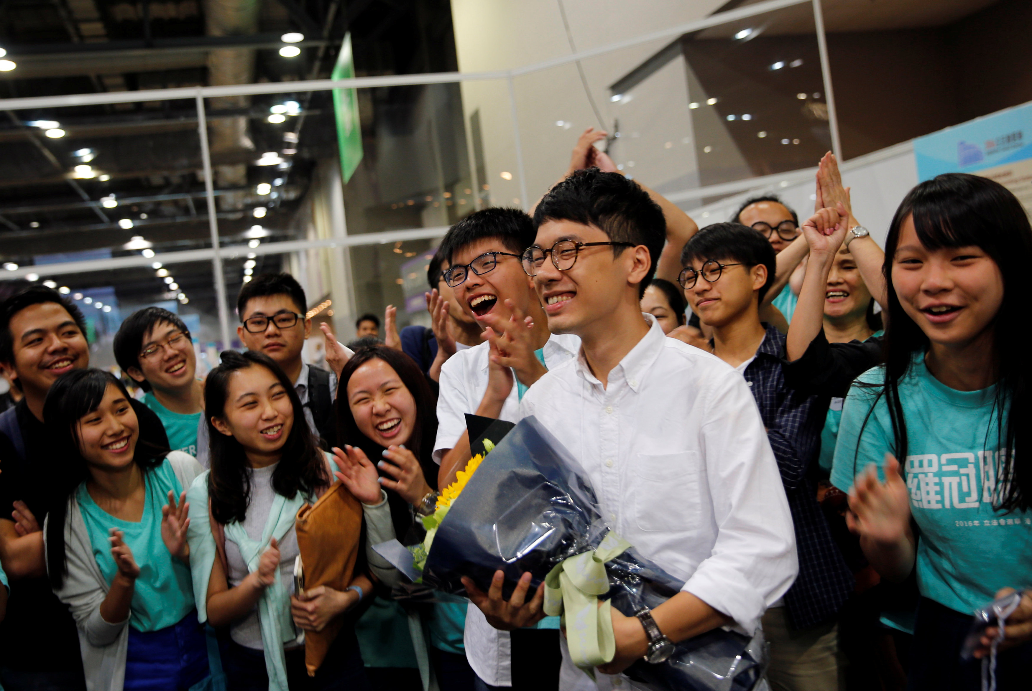 Student leader Joshua Wong (center) joins supporters in celebrating victory of Nathan Law (2nd from right) in the Legislative Council election earlier this month. Photo: Reuters Student leader Joshua Wong (center) joins supporters in celebrating victory of Nathan Law (2nd from right) in the Legislative Council election earlier this month. Photo: Reuters