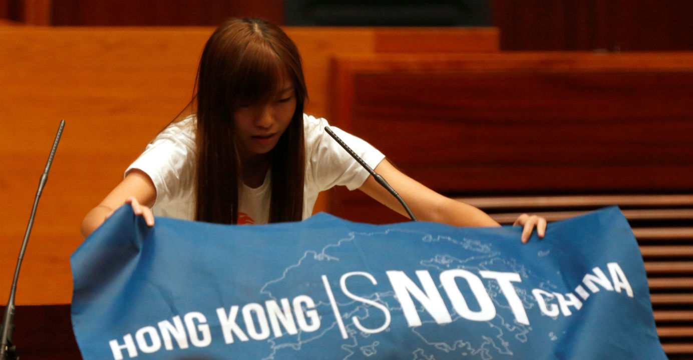 Yau Wai-ching unfurls a banner which reads "Hong Kong is not China". Photo: Reuters Yau Wai-ching unfurls a banner which reads "Hong Kong is not China". Photo: Reuters
