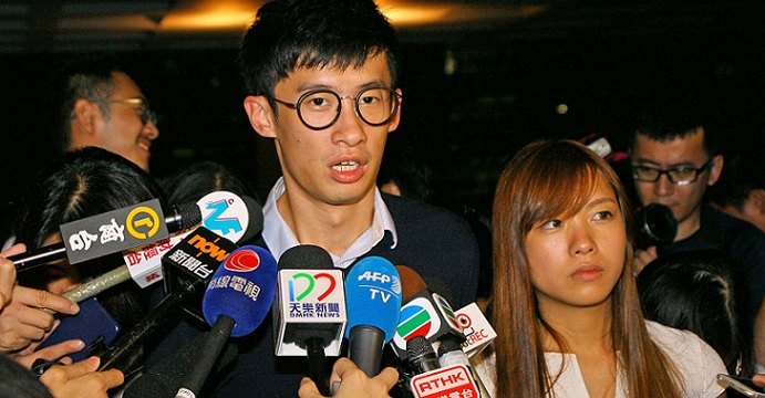 Yau Wai-ching and (right) and Sixtus Baggio Leung tell reporters after an emergency High Court hearing that they are happy with the court's rejection of an injunction. Photo: HKEJ Yau Wai-ching and (right) and Sixtus Baggio Leung tell reporters after an emergency High Court hearing that they are happy with the court's rejection of an injunction. Photo: HKEJ