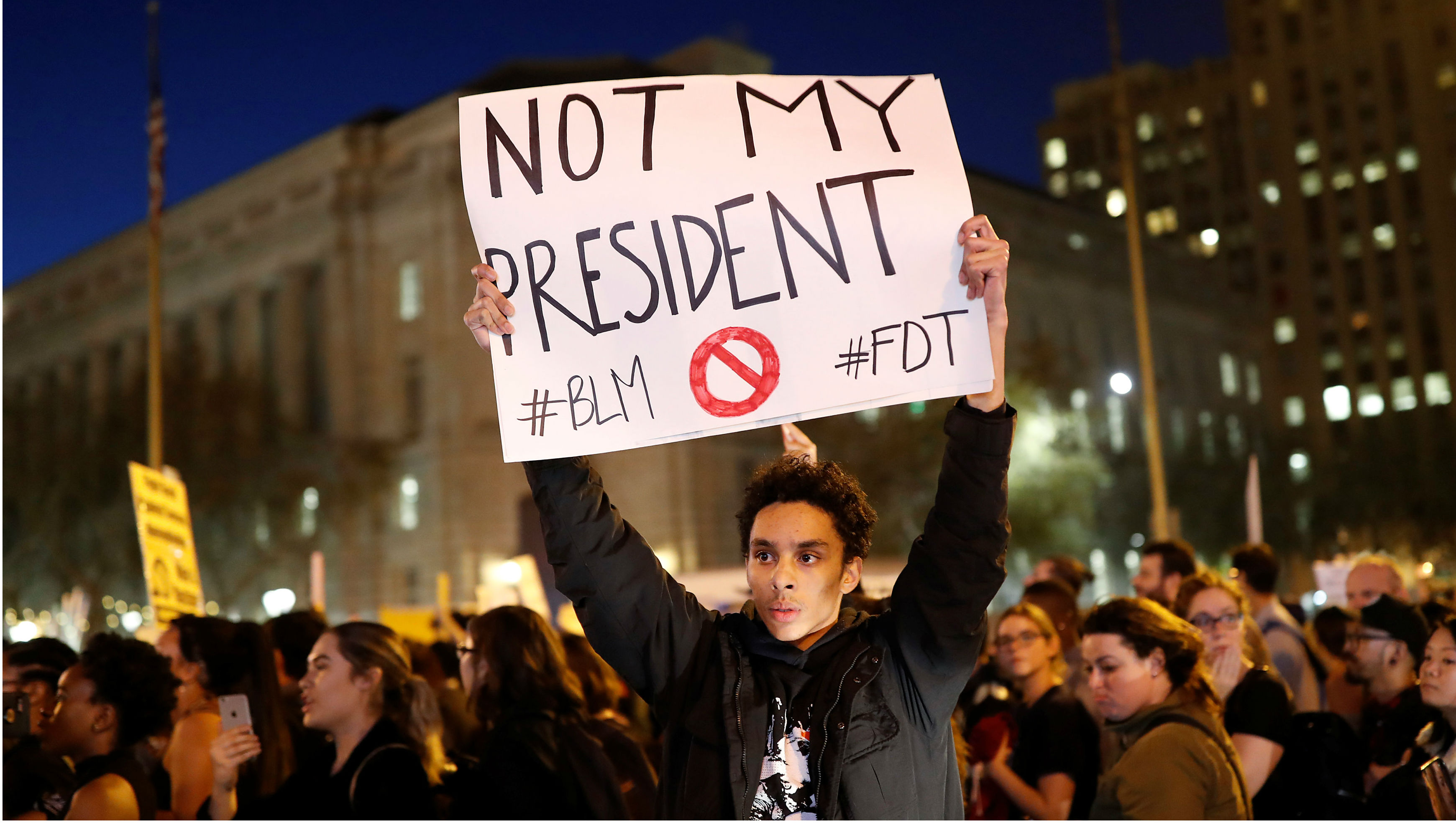 A demonstrator holds an anti-Donald Trump sign during a protest in San Francisco on Wednesday. Photo: Reuters A demonstrator holds an anti-Donald Trump sign during a protest in San Francisco on Wednesday. Photo: Reuters