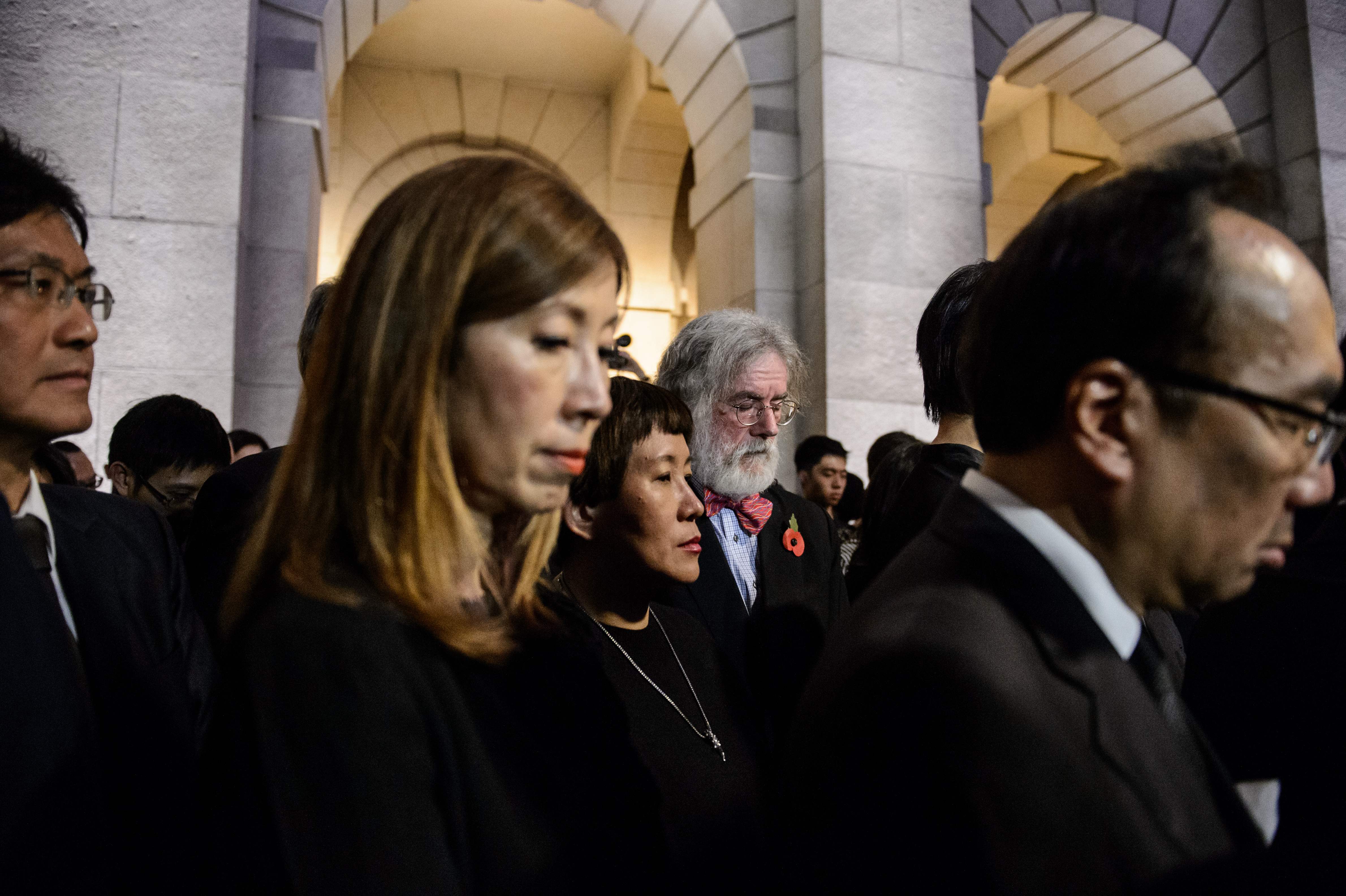 Lawyers and law students pause for three minutes of silence after a march in protest at Beijing's interpretation of the Basic Law. Photo: AFP Lawyers and law students pause for three minutes of silence after a march in protest at Beijing's interpretation of the Basic Law. Photo: AFP