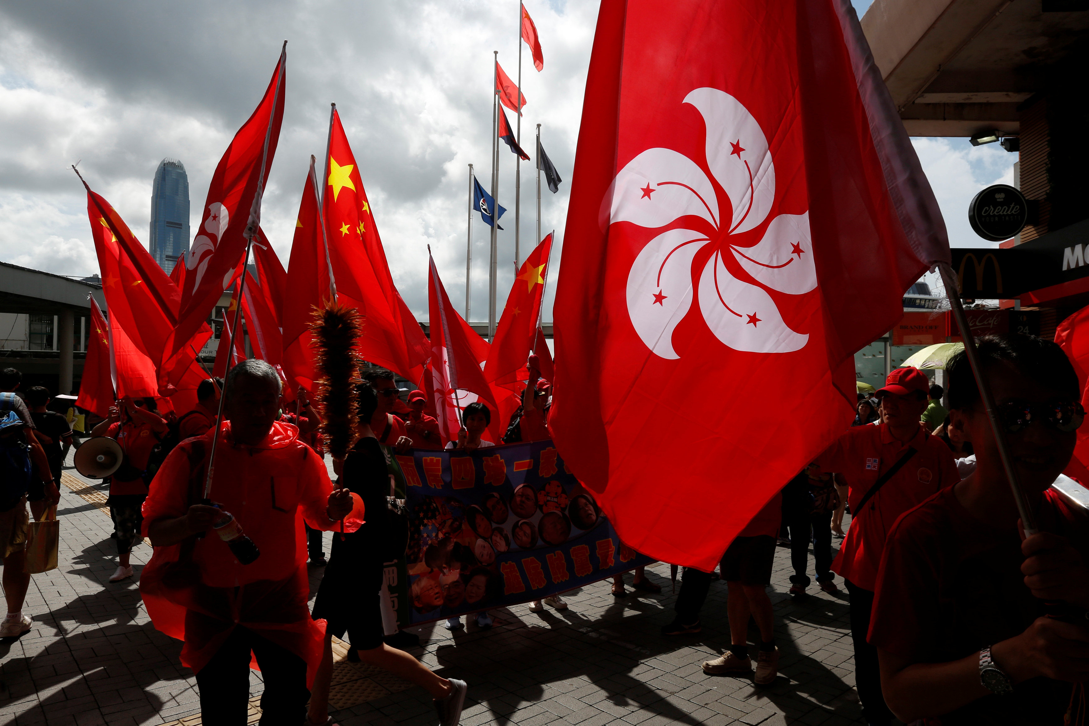 Pro-China supporters carrying a Hong Kong flag (R) and China's national flags march in Tsim Sha Tsui in this file photo. Photo: Reuters Pro-China supporters carrying a Hong Kong flag (R) and China's national flags march in Tsim Sha Tsui in this file photo. Photo: Reuters