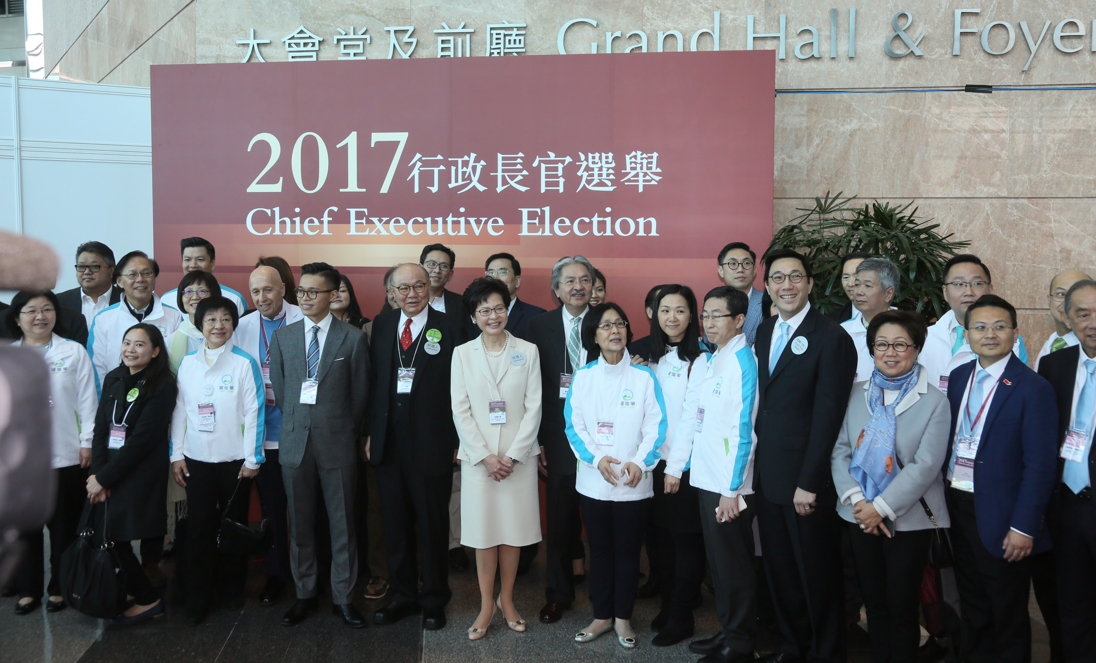The three candidates and their campaign teams pose for a group picture prior to Sunday's election. Photo: HKEJ The three candidates and their campaign teams pose for a group picture prior to Sunday's election. Photo: HKEJ