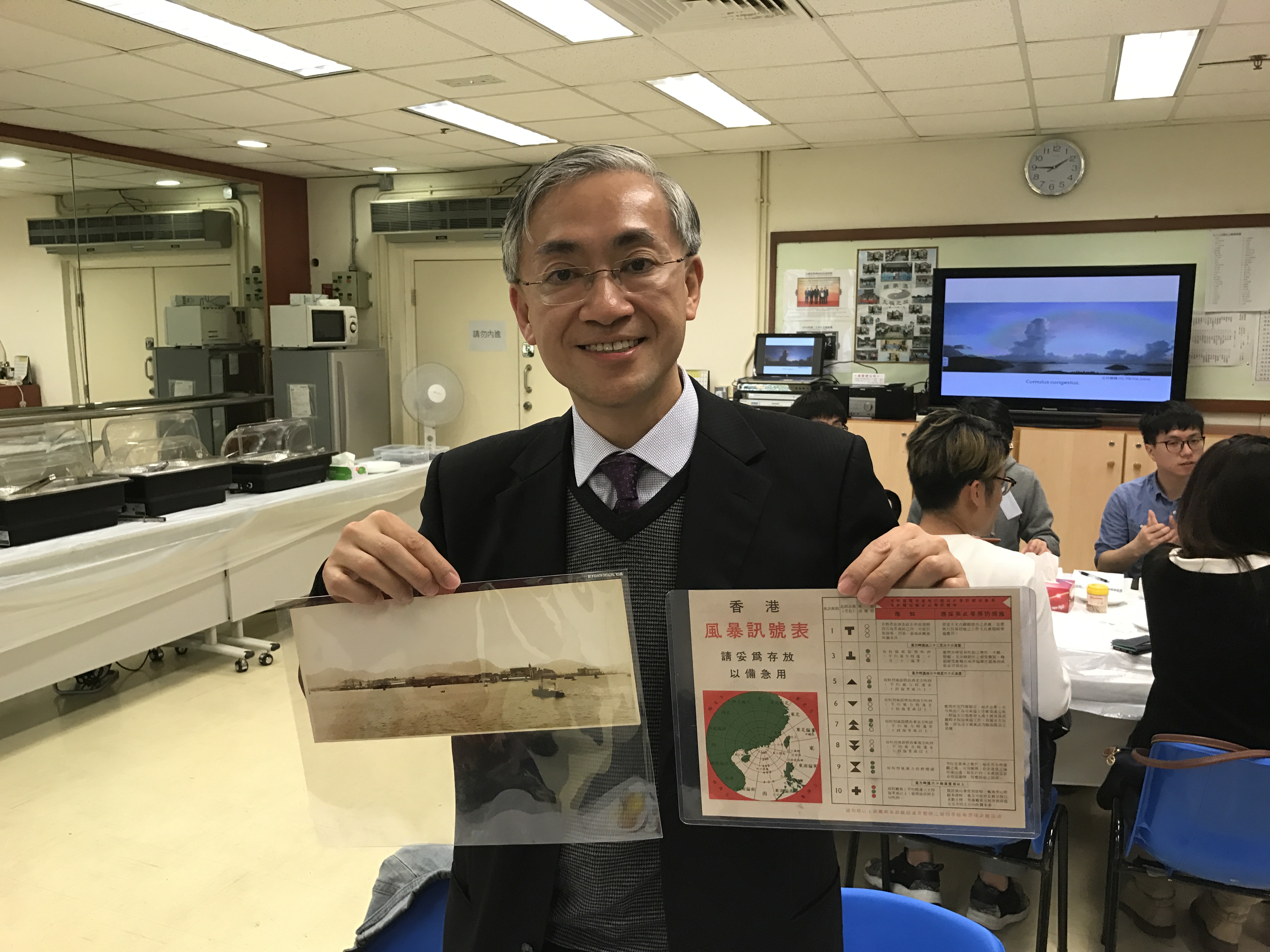 Shun Chi-ming shows an old storm and hurricane warming leaflet distributed to residents during the old days when there was no TV or smartphone. Photo: HKEJ Shun Chi-ming shows an old storm and hurricane warming leaflet distributed to residents during the old days when there was no TV or smartphone. Photo: HKEJ