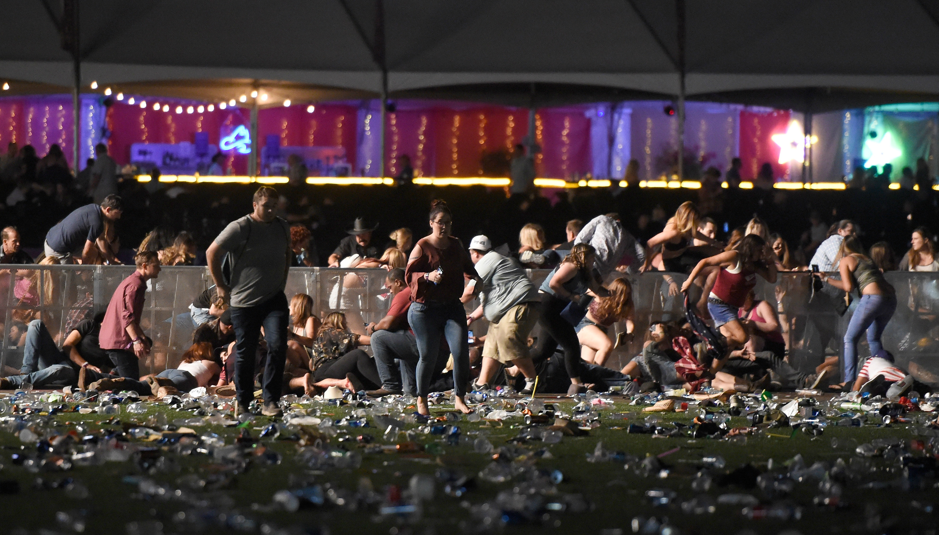People attending the Route 91 Harvest Music Festival run for cover as gunfire is heard in Las Vegas, Nevada, on Sunday night. Photo: AFP People attending the Route 91 Harvest Music Festival run for cover as gunfire is heard in Las Vegas, Nevada, on Sunday night. Photo: AFP