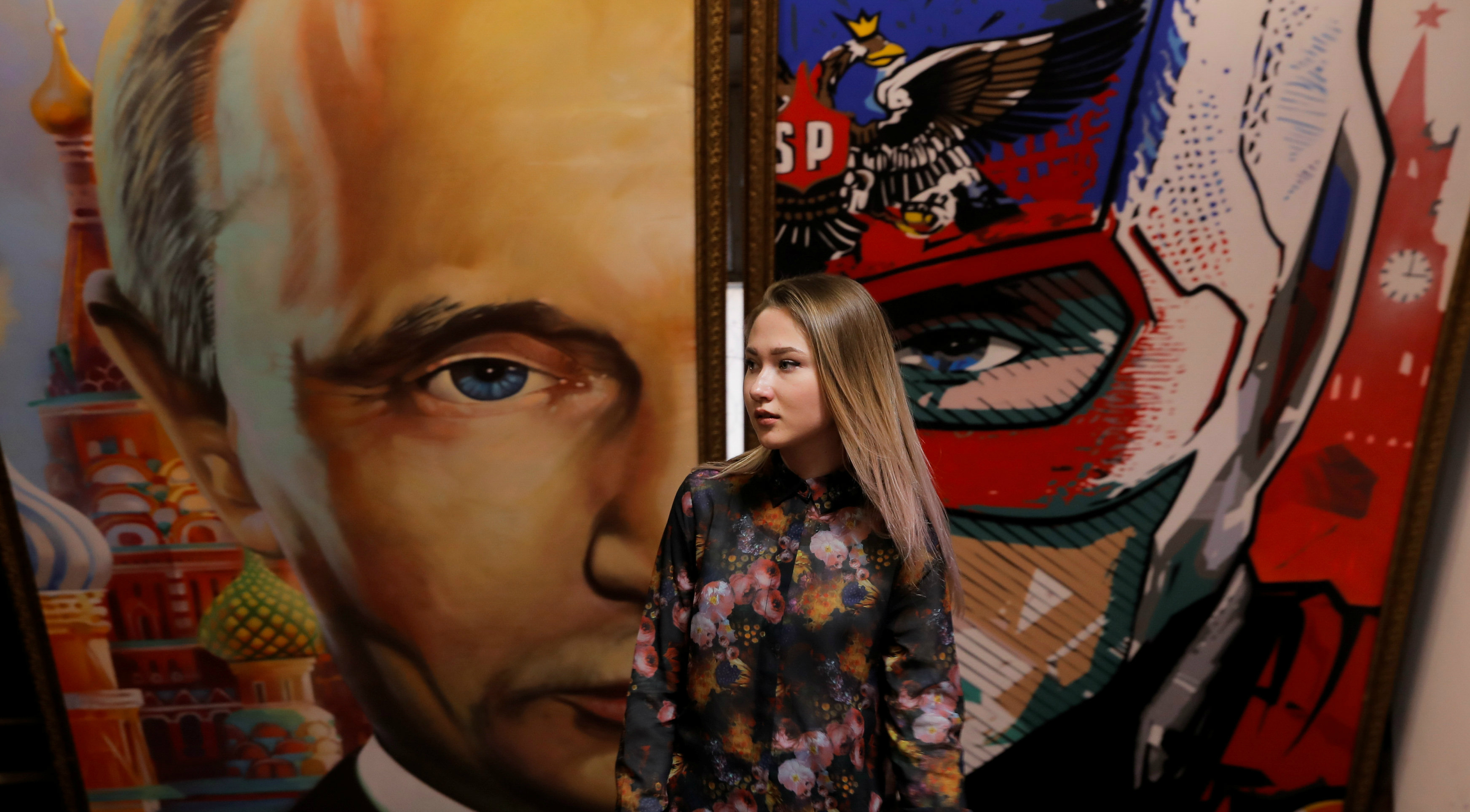 A woman stands in front of a painting depicting Russian President Vladimir Putin at the "SUPERPUTIN" exhibition at UMAM museum in Moscow on Wednesday. Photo: Reuters A woman stands in front of a painting depicting Russian President Vladimir Putin at the "SUPERPUTIN" exhibition at UMAM museum in Moscow on Wednesday. Photo: Reuters