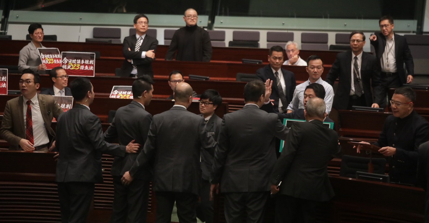 Several pro-democracy lawmakers stage a protest during a Legco meeting. Meanwhile, the pro-Beijing camp is preparing to ramp up the battle over amendments to the Legco rules of procedure. Photo: HKEJ Several pro-democracy lawmakers stage a protest during a Legco meeting. Meanwhile, the pro-Beijing camp is preparing to ramp up the battle over amendments to the Legco rules of procedure. Photo: HKEJ