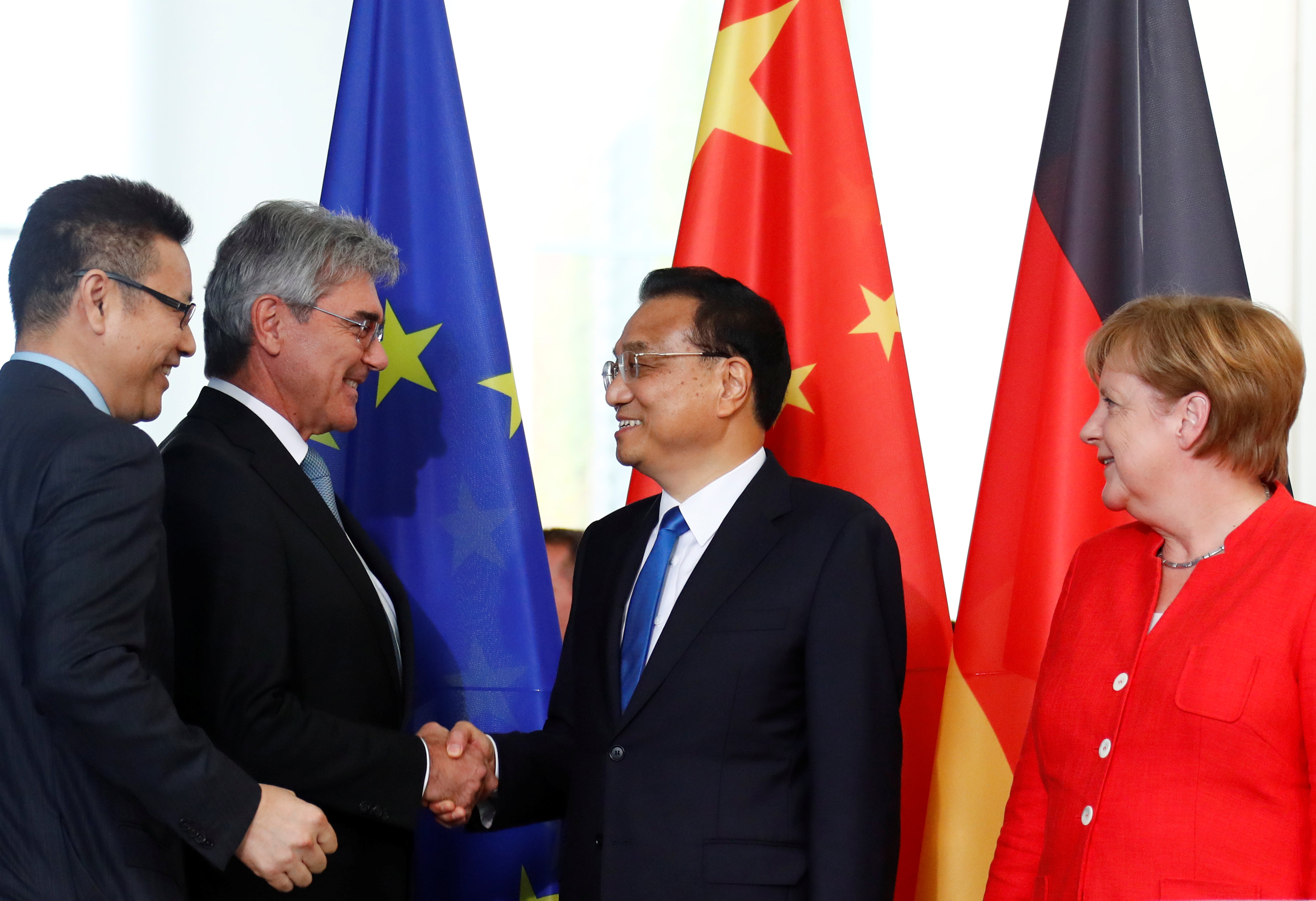 Chinese Prime Minister Li Keqiang shakes hands with Siemens CEO Joe Kaeser as German Chancellor Angela Merkel looks on during a signing ceremony in Berlin on Monday for some commercial accords. Photo: Reuters Chinese Prime Minister Li Keqiang shakes hands with Siemens CEO Joe Kaeser as German Chancellor Angela Merkel looks on during a signing ceremony in Berlin on Monday for some commercial accords. Photo: Reuters