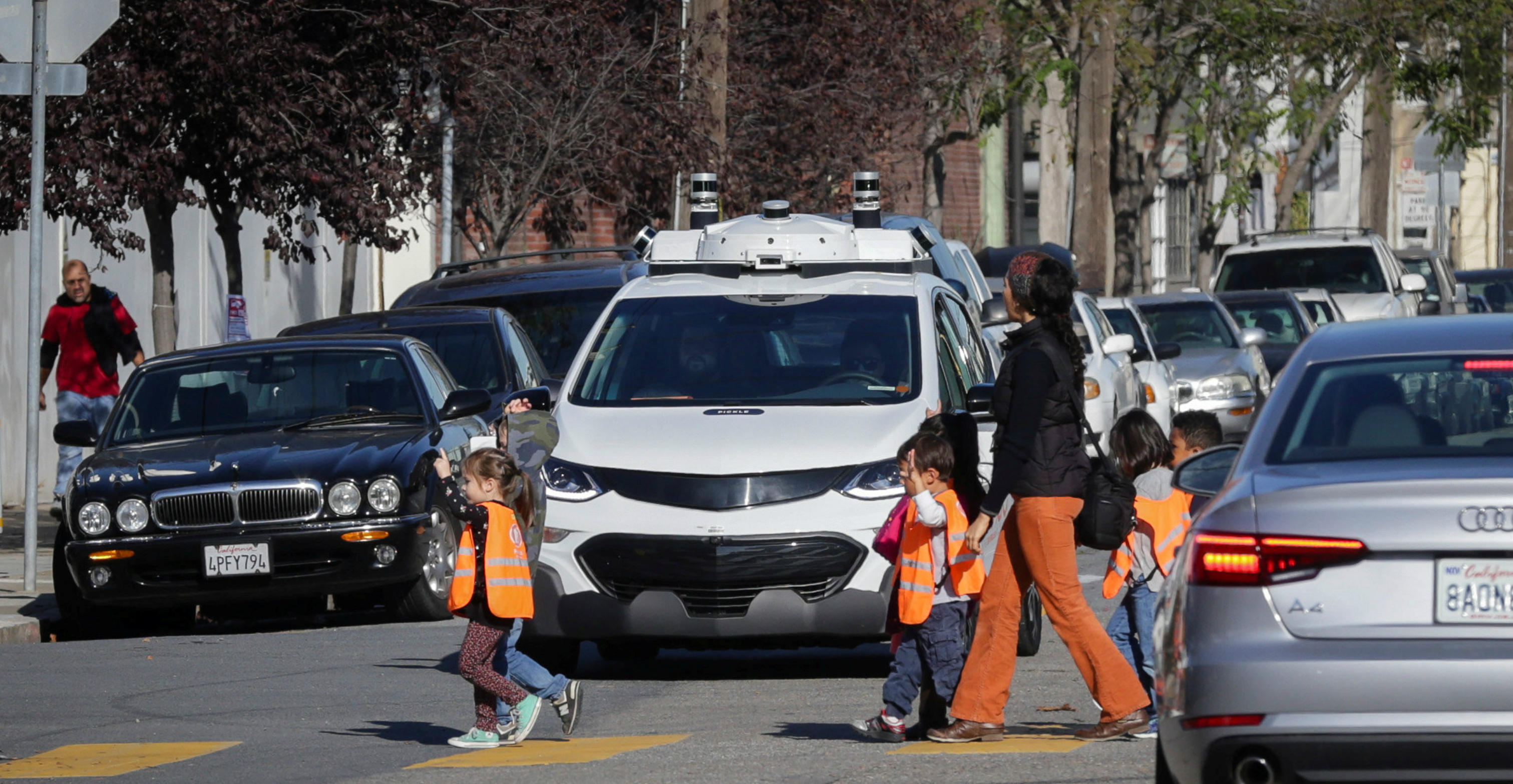 Schoolchildren pass by a self-driving GM Bolt electric vehicle during a media event in San Francisco last year. Photo: Reuters Schoolchildren pass by a self-driving GM Bolt electric vehicle during a media event in San Francisco last year. Photo: Reuters