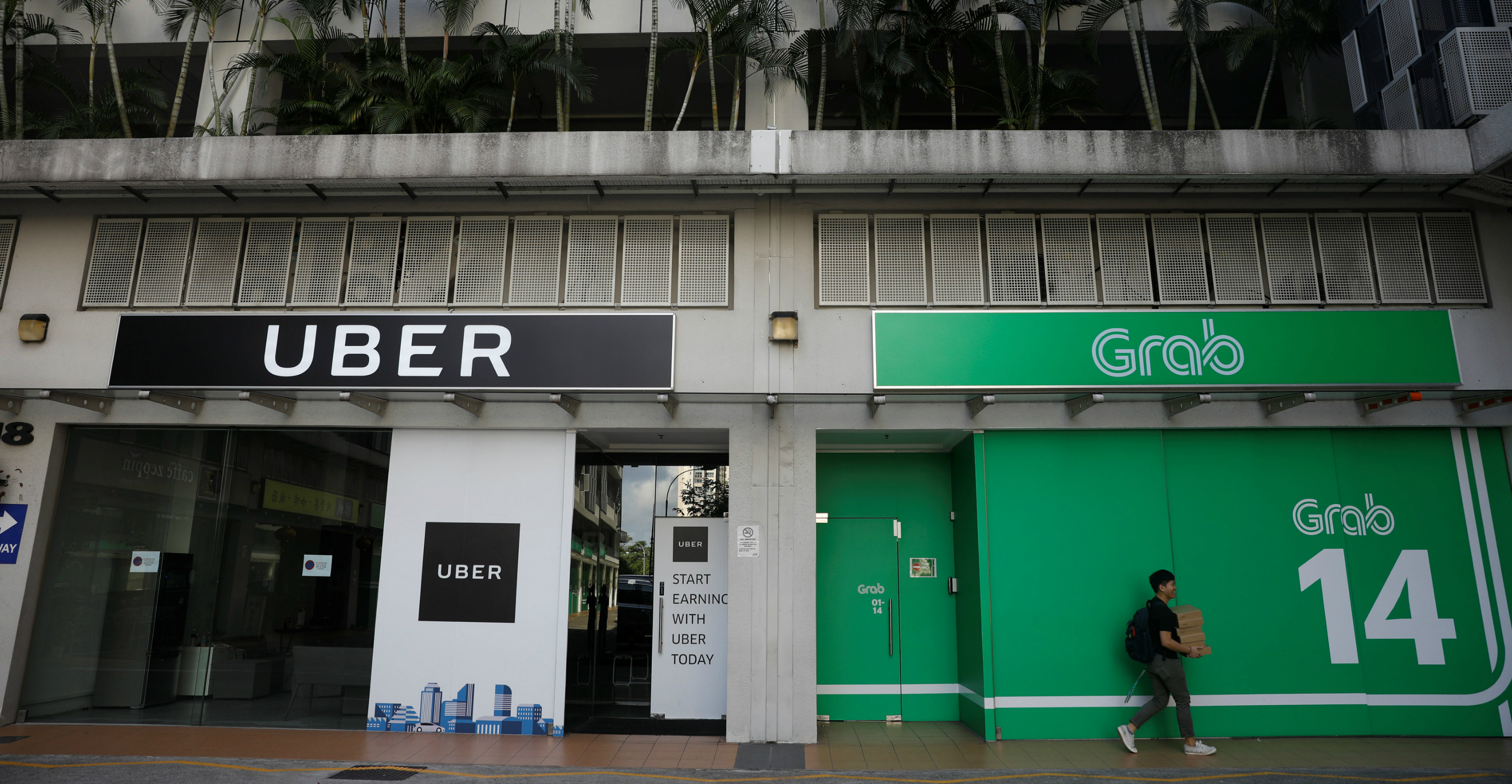Singapore last month slapped ride-hailing firms Grab and Uber with fines and imposed restrictions on their businesses to open up the market to competitors, after concluding that their merger had driven up prices. Photo: Reuters Singapore last month slapped ride-hailing firms Grab and Uber with fines and imposed restrictions on their businesses to open up the market to competitors, after concluding that their merger had driven up prices. Photo: Reuters