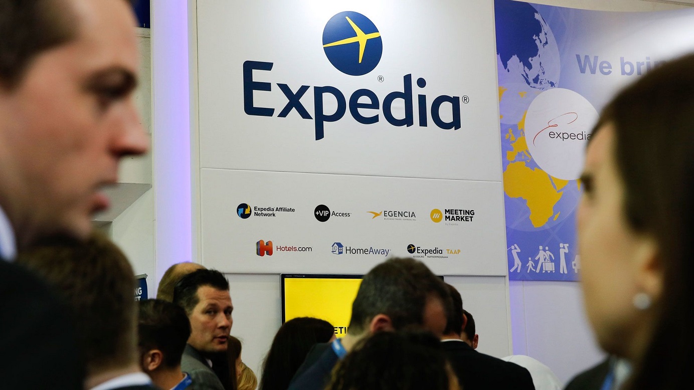 Visitors browse at the display of Expedia during a trade fair. The travel booking site is taking aim at Airbnb in the home-rental market. Photo: Reuters Visitors browse at the display of Expedia during a trade fair. The travel booking site is taking aim at Airbnb in the home-rental market. Photo: Reuters