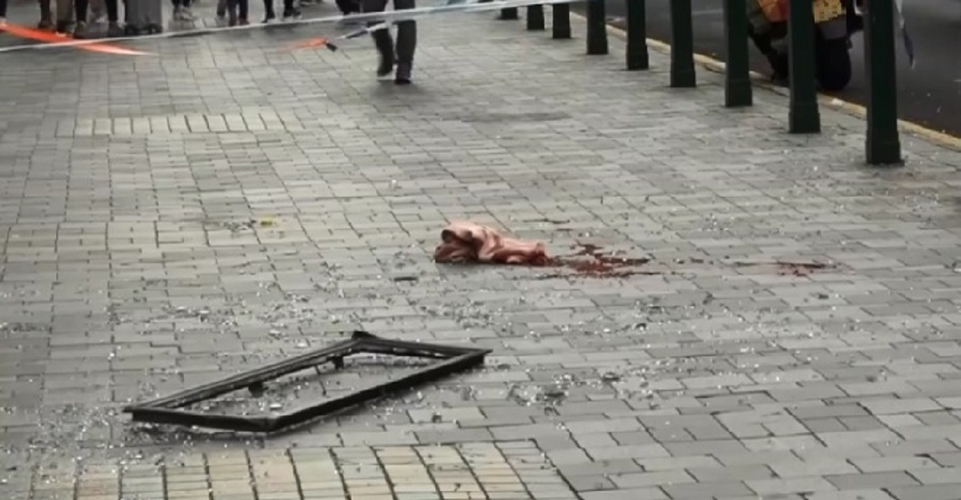 Police cordon off a portion of the pavement where a 24-year-old mainland woman was killed after she was hit in the head by a falling window from The Mira hotel on Nathan Road in Tsim Sha Tsui on Monday morning. Photo: RTHK Police cordon off a portion of the pavement where a 24-year-old mainland woman was killed after she was hit in the head by a falling window from The Mira hotel on Nathan Road in Tsim Sha Tsui on Monday morning. Photo: RTHK