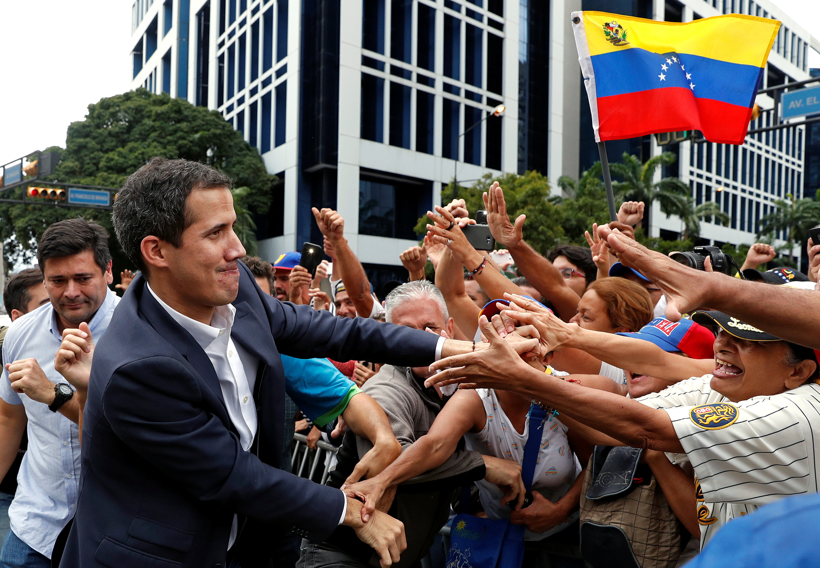 Venezuelan opposition leader Juan Guaido greets supporters during a rally on Wednesday in Caracas against the Nicolas Maduro government. Photo: Reuters Venezuelan opposition leader Juan Guaido greets supporters during a rally on Wednesday in Caracas against the Nicolas Maduro government. Photo: Reuters