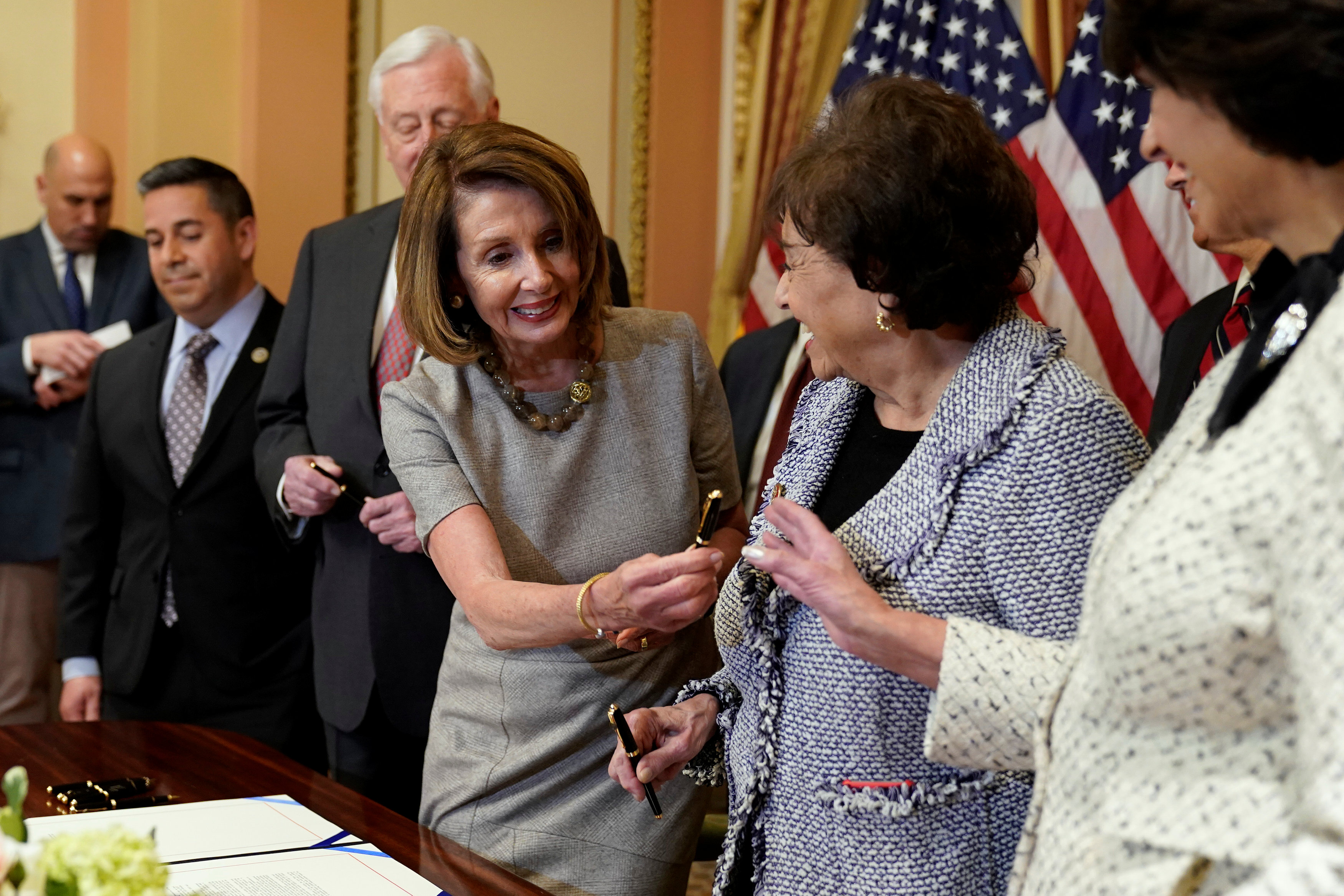 Speaker of the House Nancy Pelosi distributes pens after signing legislation in Washington on Jan. 25 before sending it to President Donald Trump for his signature to end the partial government shutdown. Photo: Reuters Speaker of the House Nancy Pelosi distributes pens after signing legislation in Washington on Jan. 25 before sending it to President Donald Trump for his signature to end the partial government shutdown. Photo: Reuters