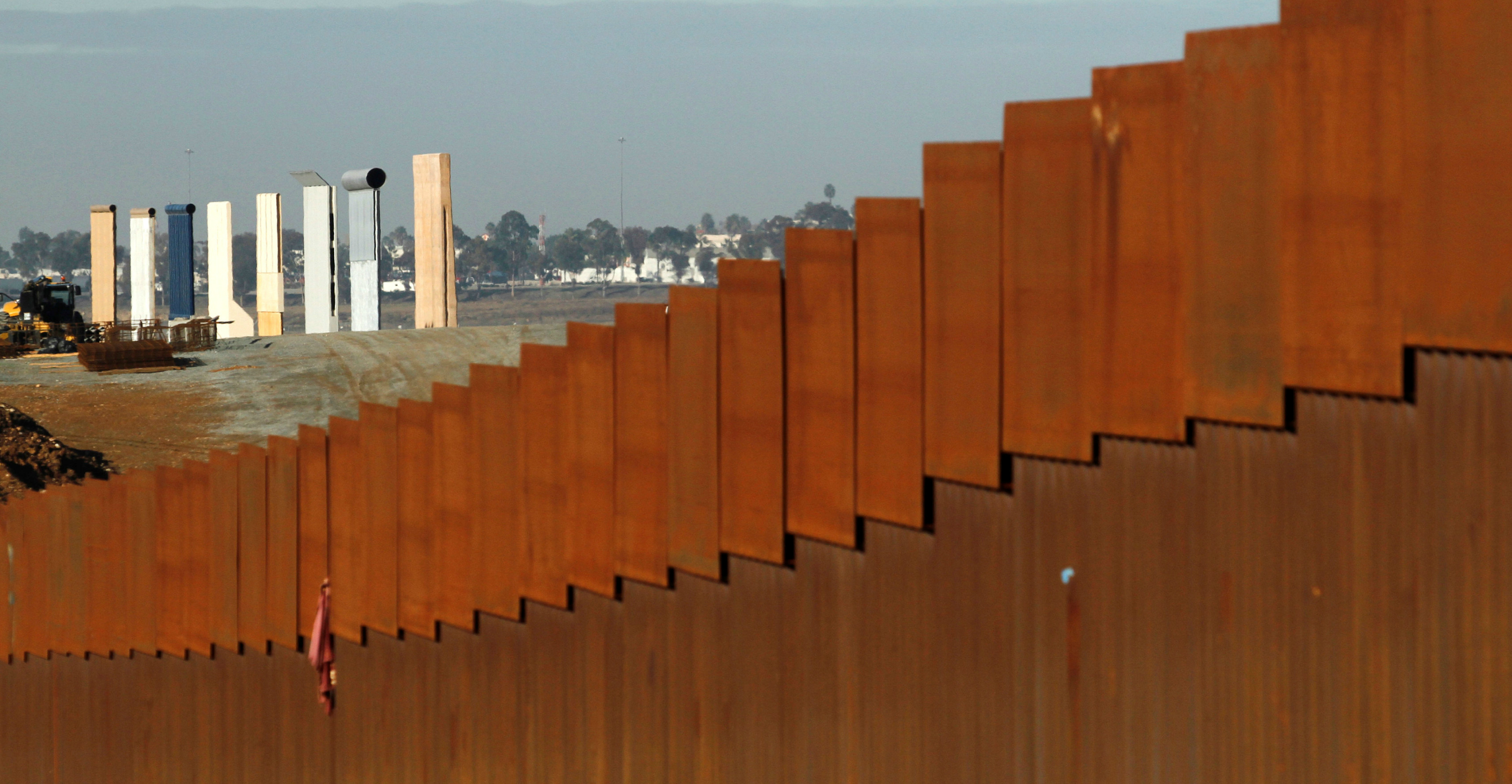 Prototypes for US President Donald Trump's border wall are seen behind the border fence between Mexico and the United States, in Tijuana, Mexico. Photo: Reuters Prototypes for US President Donald Trump's border wall are seen behind the border fence between Mexico and the United States, in Tijuana, Mexico. Photo: Reuters