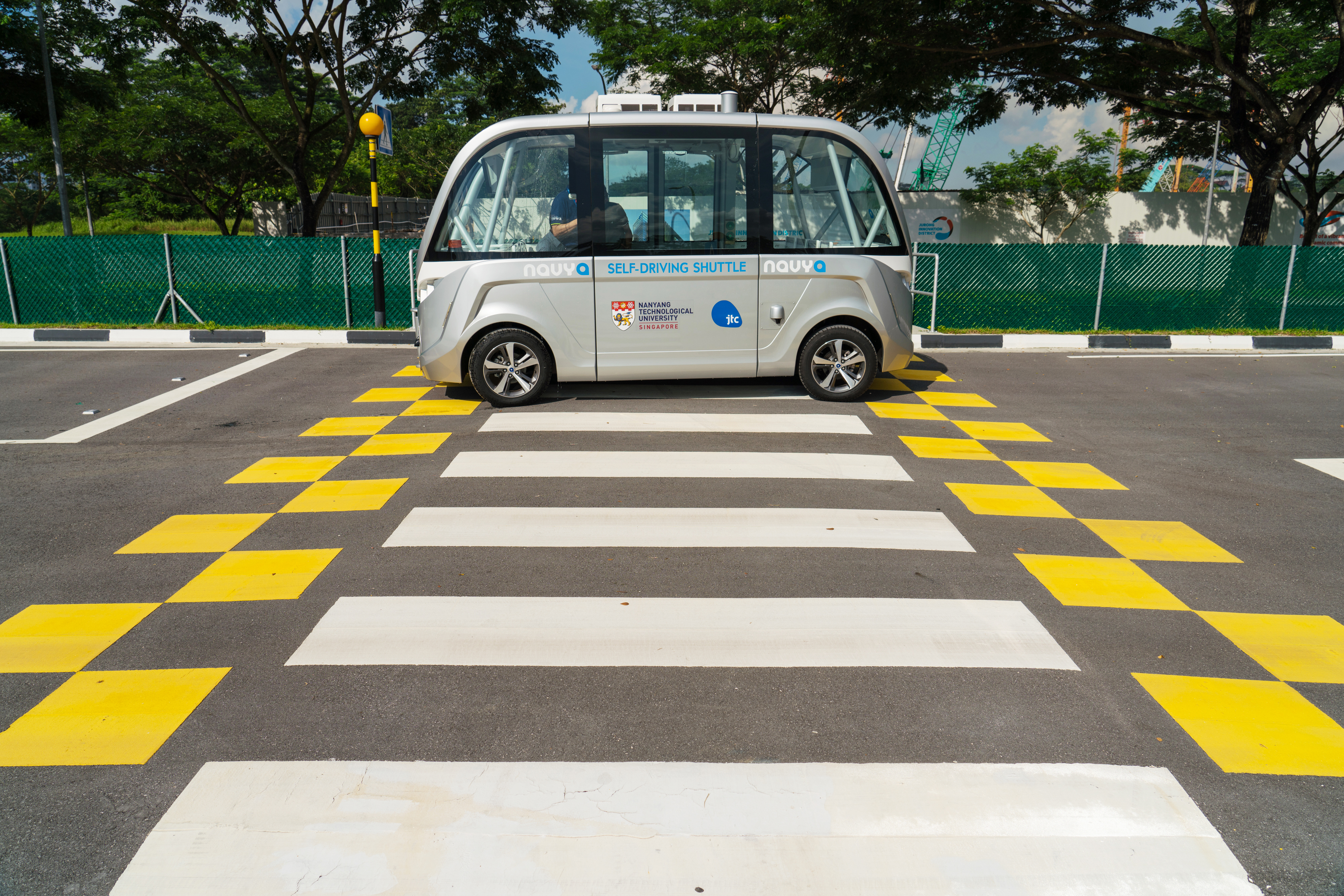 A Navya SAS autonomous electric passenger bus travels past a crosswalk at a test circuit of Nanyang Technology University in Singapore on May 22, 2018. Photo: Bloomberg A Navya SAS autonomous electric passenger bus travels past a crosswalk at a test circuit of Nanyang Technology University in Singapore on May 22, 2018. Photo: Bloomberg