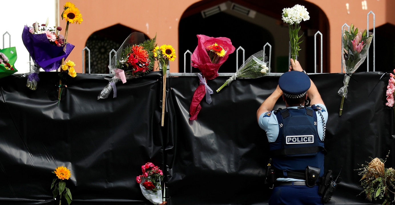 A police officer places flowers at the entrance of Masjid Al Noor in Christchurch, New Zealand on Sunday. Decision-makers around the world should closely stand by pluralism. Photo: Reuters A police officer places flowers at the entrance of Masjid Al Noor in Christchurch, New Zealand on Sunday. Decision-makers around the world should closely stand by pluralism. Photo: Reuters