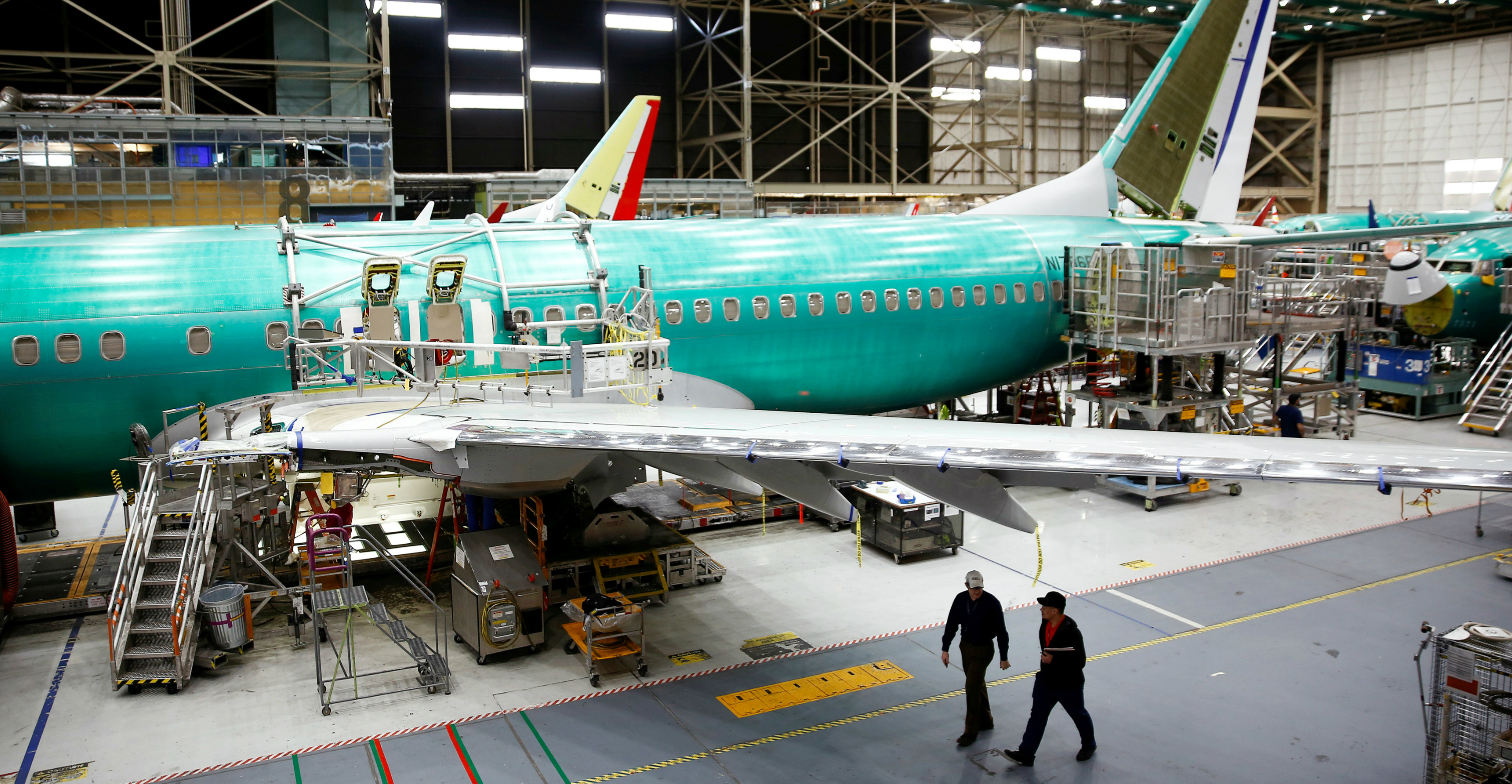 Two workers walk under the wing of a 737 Max aircraft at the Boeing factory in Renton, Washington, on Wednesday. Photo: Reuters Two workers walk under the wing of a 737 Max aircraft at the Boeing factory in Renton, Washington, on Wednesday. Photo: Reuters