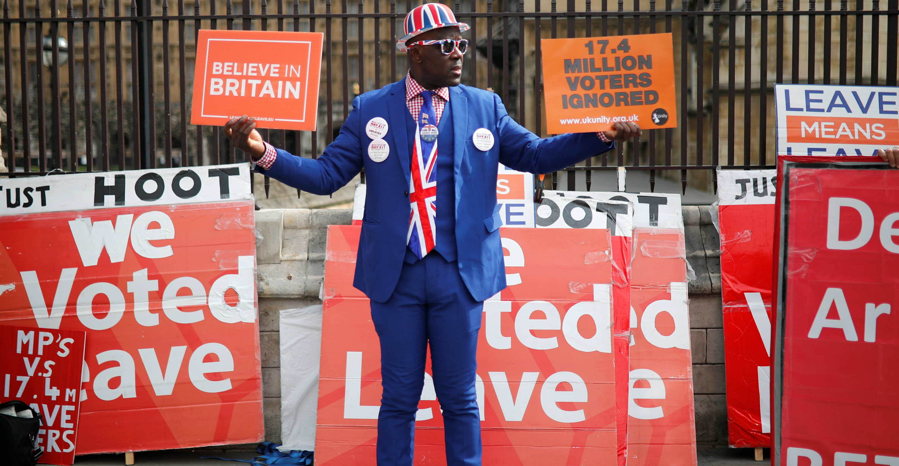 A pro-Brexit demonstrator holds placards outside the Houses of Parliament in London on Thursday. Photo: Reuters A pro-Brexit demonstrator holds placards outside the Houses of Parliament in London on Thursday. Photo: Reuters