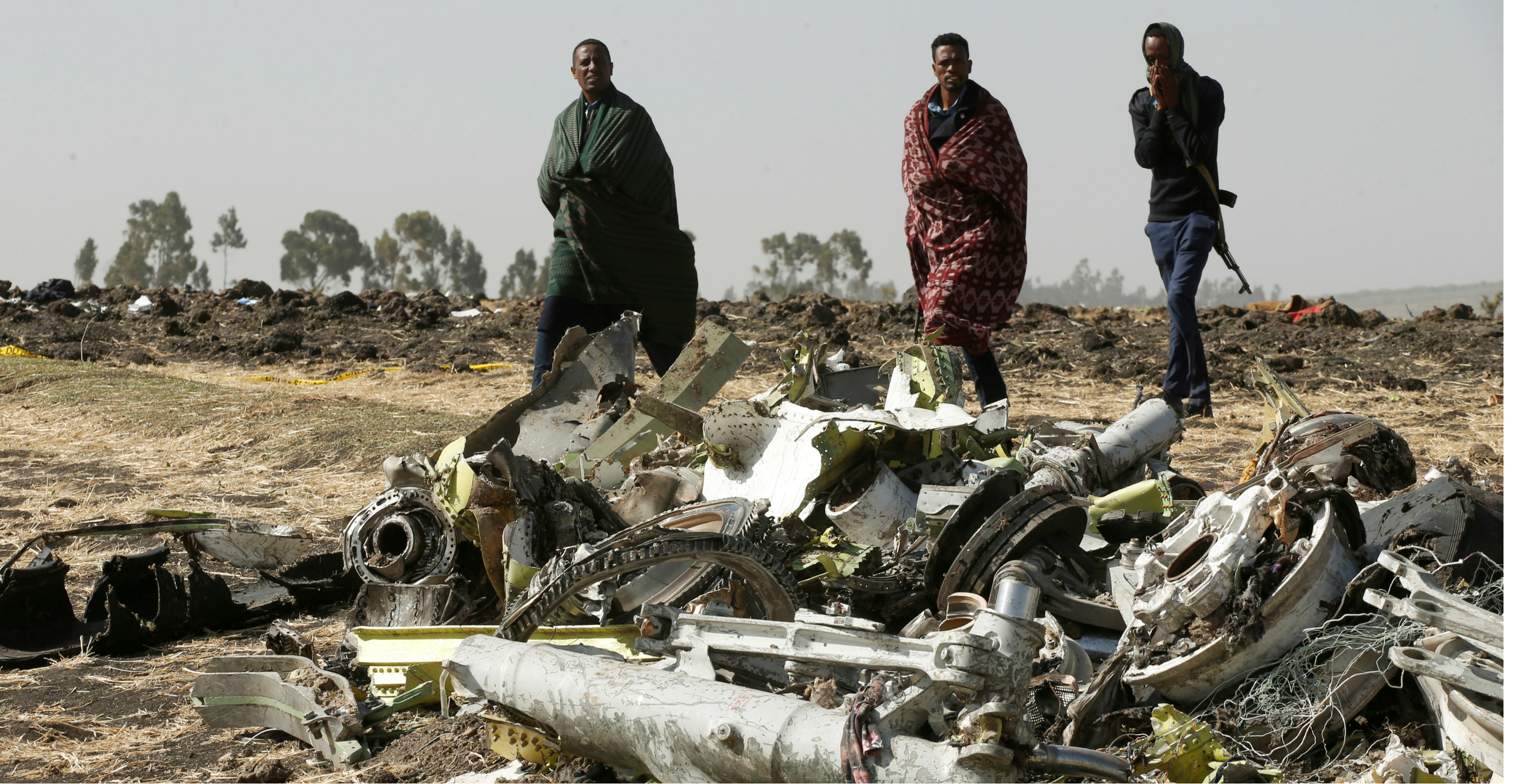 Police officers walk past the debris of the Ethiopian Airlines Flight ET 302 plane crash, near Addis Ababa on March 12. Photo: Reuters Police officers walk past the debris of the Ethiopian Airlines Flight ET 302 plane crash, near Addis Ababa on March 12. Photo: Reuters