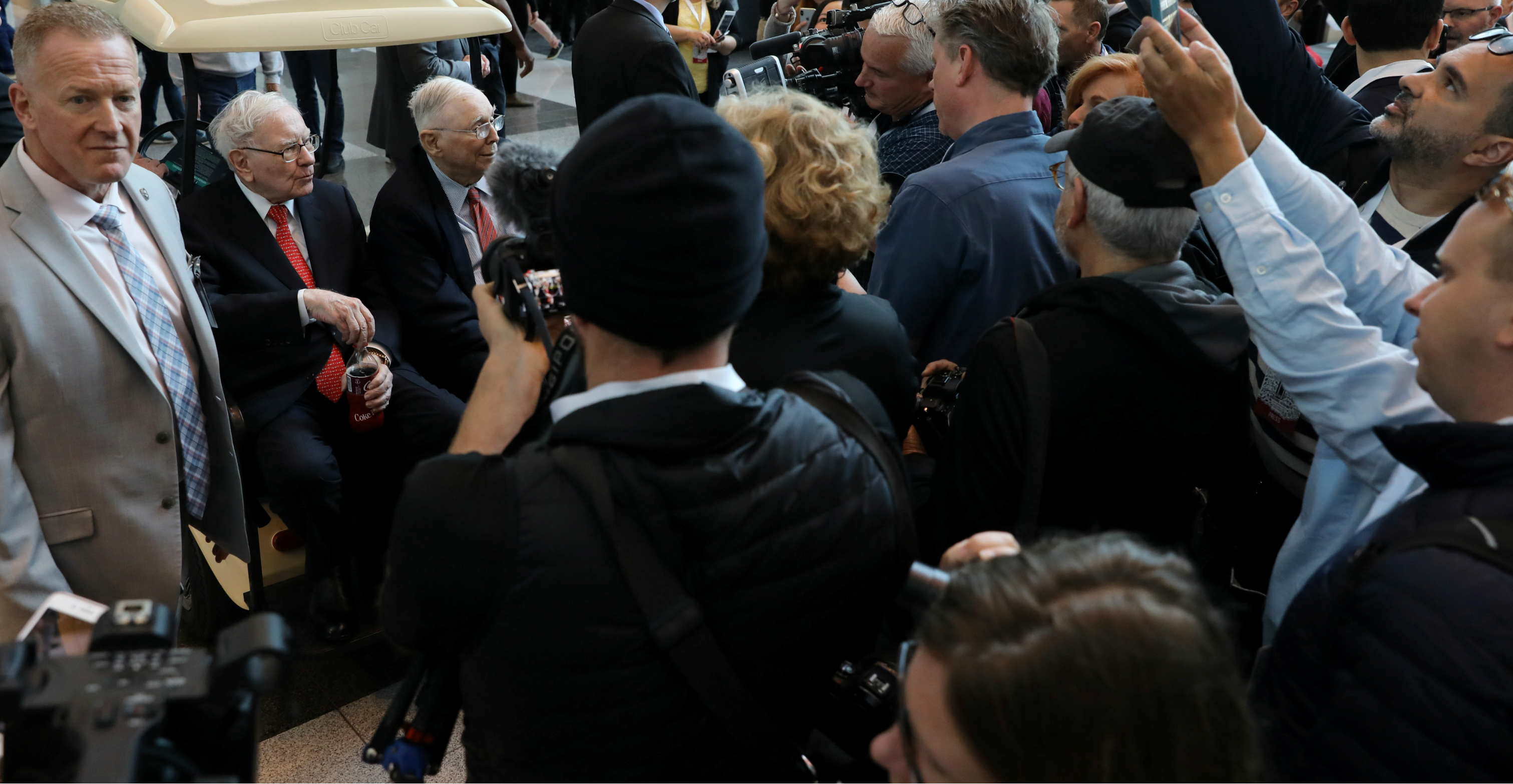 Berkshire Hathaway chairman Warren Buffett and vice chairman Charles Munger are mobbed by media representatives and fans before the company's annual shareholder meeting in Omaha, Nebraska, on Saturday. Photo: Reuters Berkshire Hathaway chairman Warren Buffett and vice chairman Charles Munger are mobbed by media representatives and fans before the company's annual shareholder meeting in Omaha, Nebraska, on Saturday. Photo: Reuters