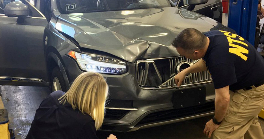 Investigators examine an autonomous Uber vehicle involved in a fatal accident in Arizona last year. Photo: Reuters Investigators examine an autonomous Uber vehicle involved in a fatal accident in Arizona last year. Photo: Reuters
