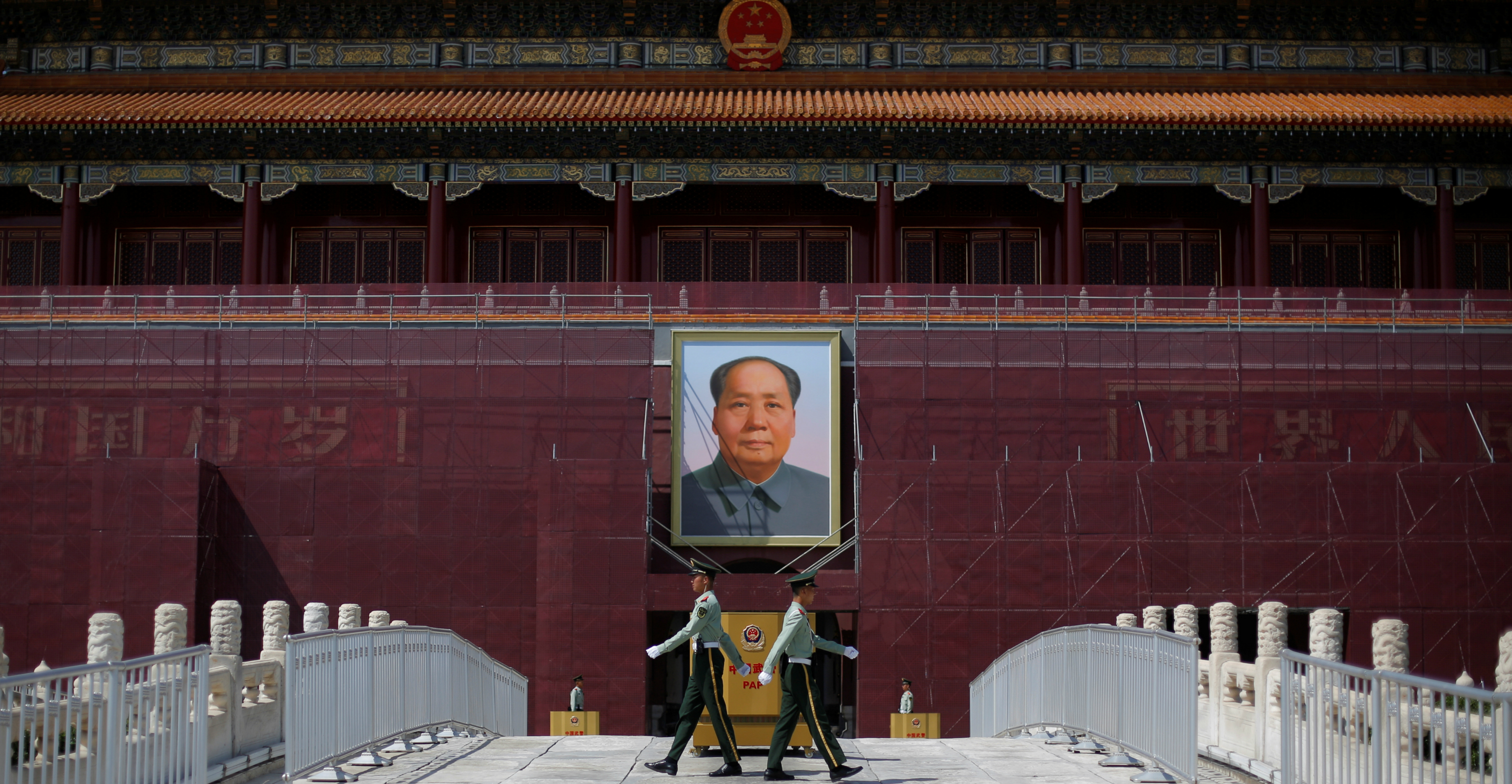 Paramilitary officers change the guard in front of a portrait of Chairman Mao Zedong in Tiananmen Square. Photo: Reuters Paramilitary officers change the guard in front of a portrait of Chairman Mao Zedong in Tiananmen Square. Photo: Reuters